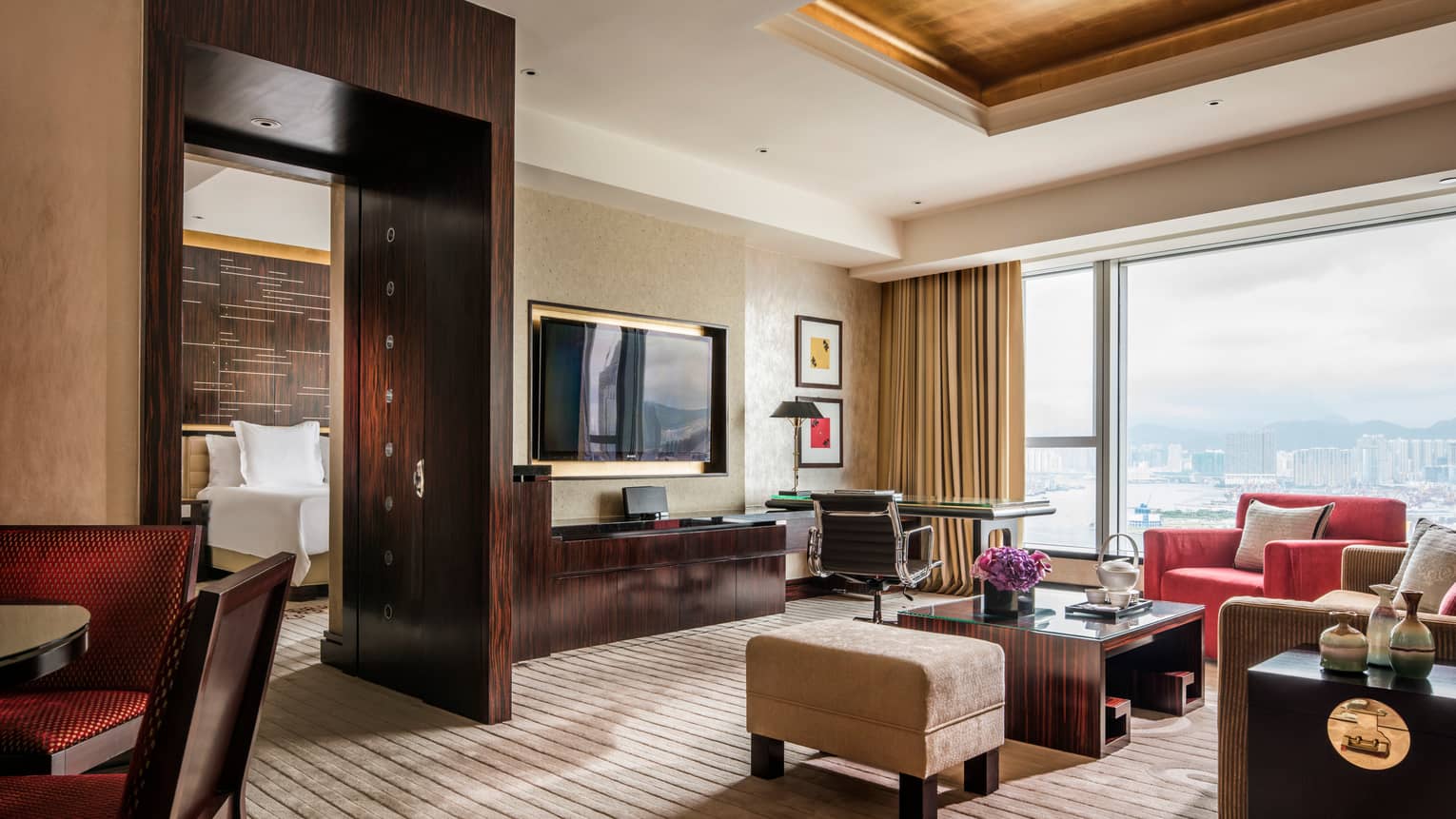 Harbour-View Suite living room with dark wood accents, sunny window, separate bedroom