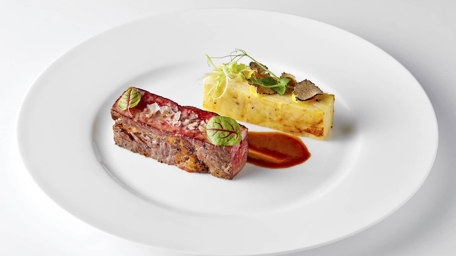 Grilled Hanwoo beef sirloin with accompanied food on white plate