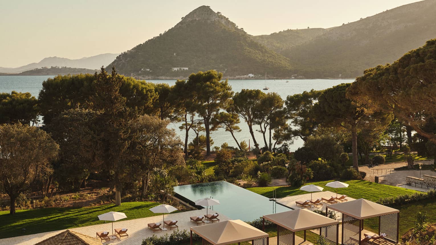 View of pool and ocean/mountain in background