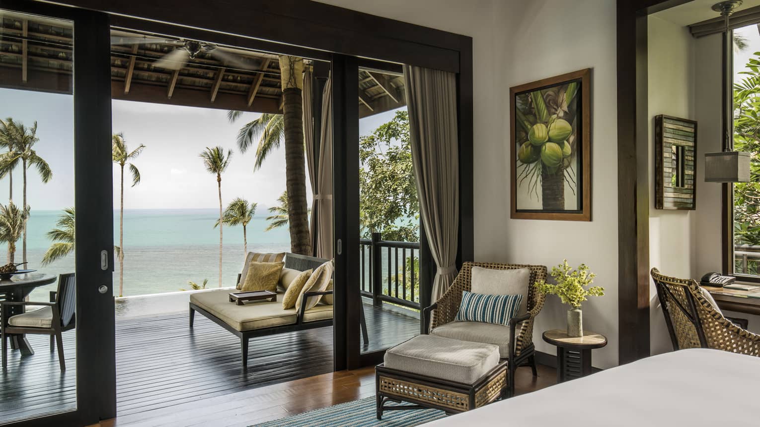 Villa bedroom with queen bed, rattan furniture and private beach access 