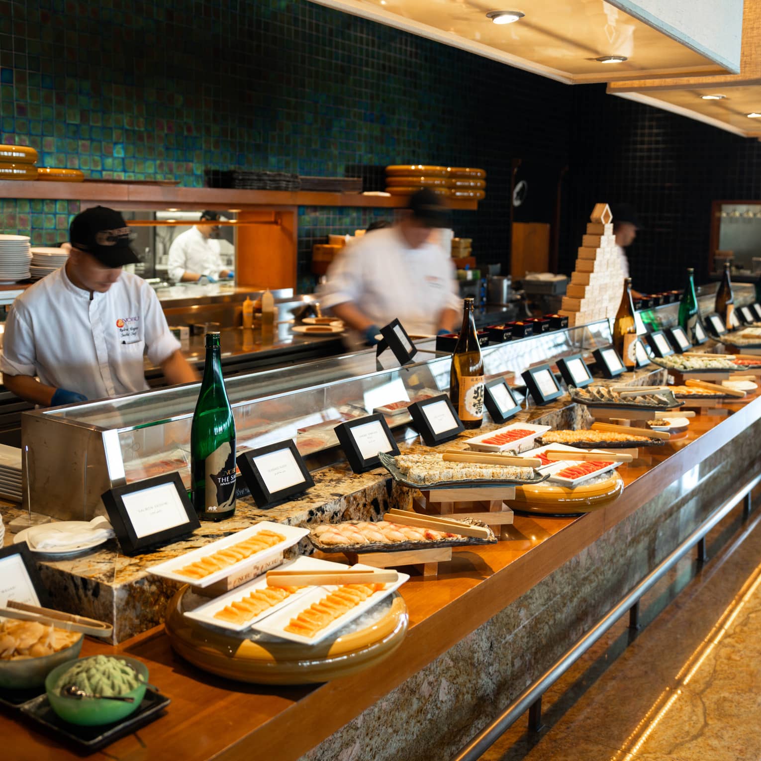 Brunch buffet set up in front of an open kitchen with chefs working