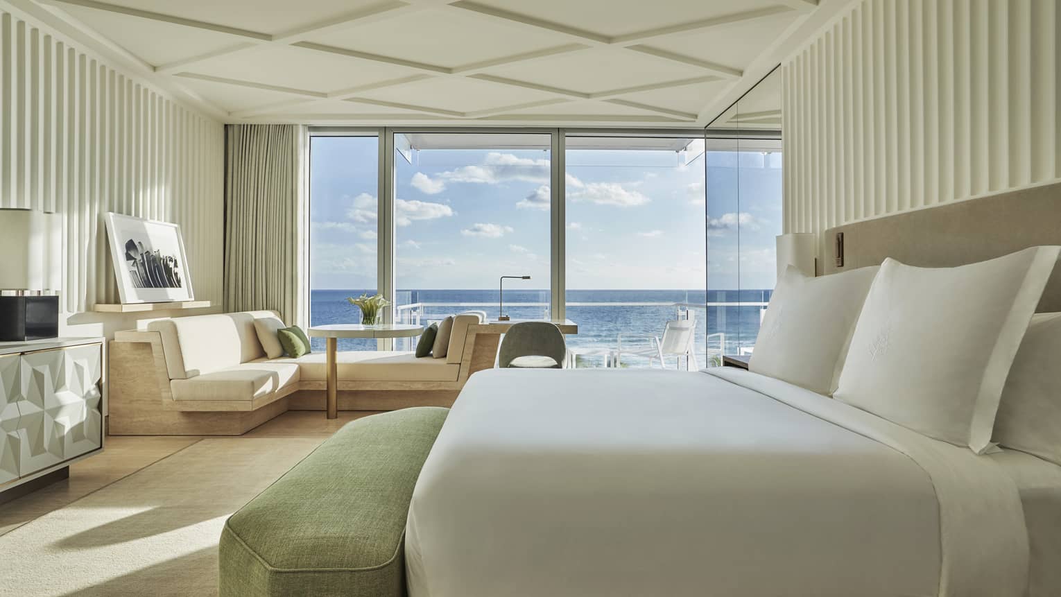 Oceanfront Room with bed, L-shaped sofa, desk, and balcony with Atlantic ocean views