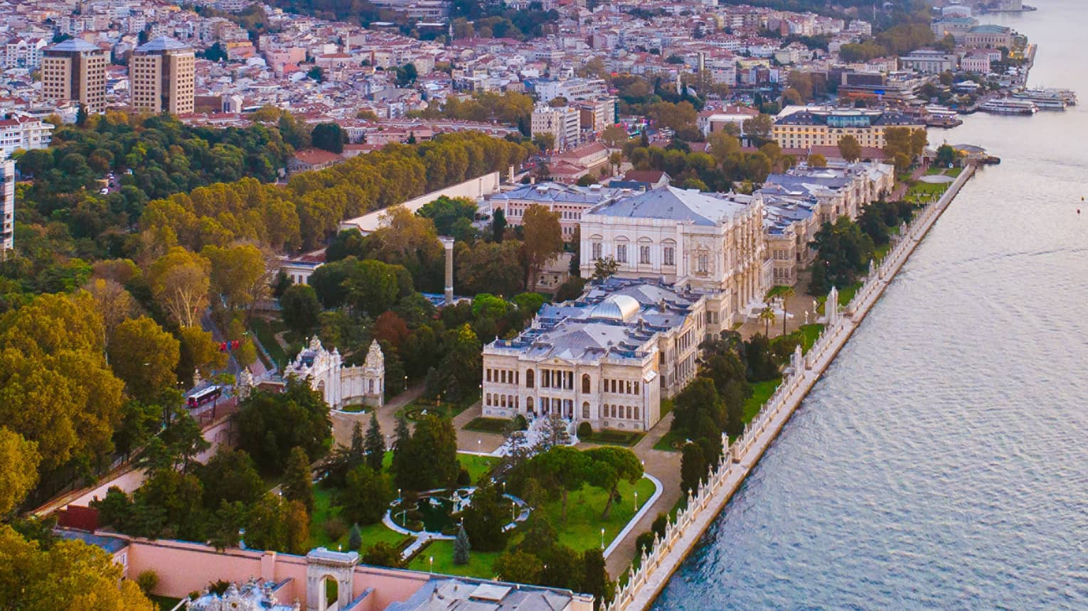 Dolmabahçe Sarayı aerial view of buildings by water at sunset