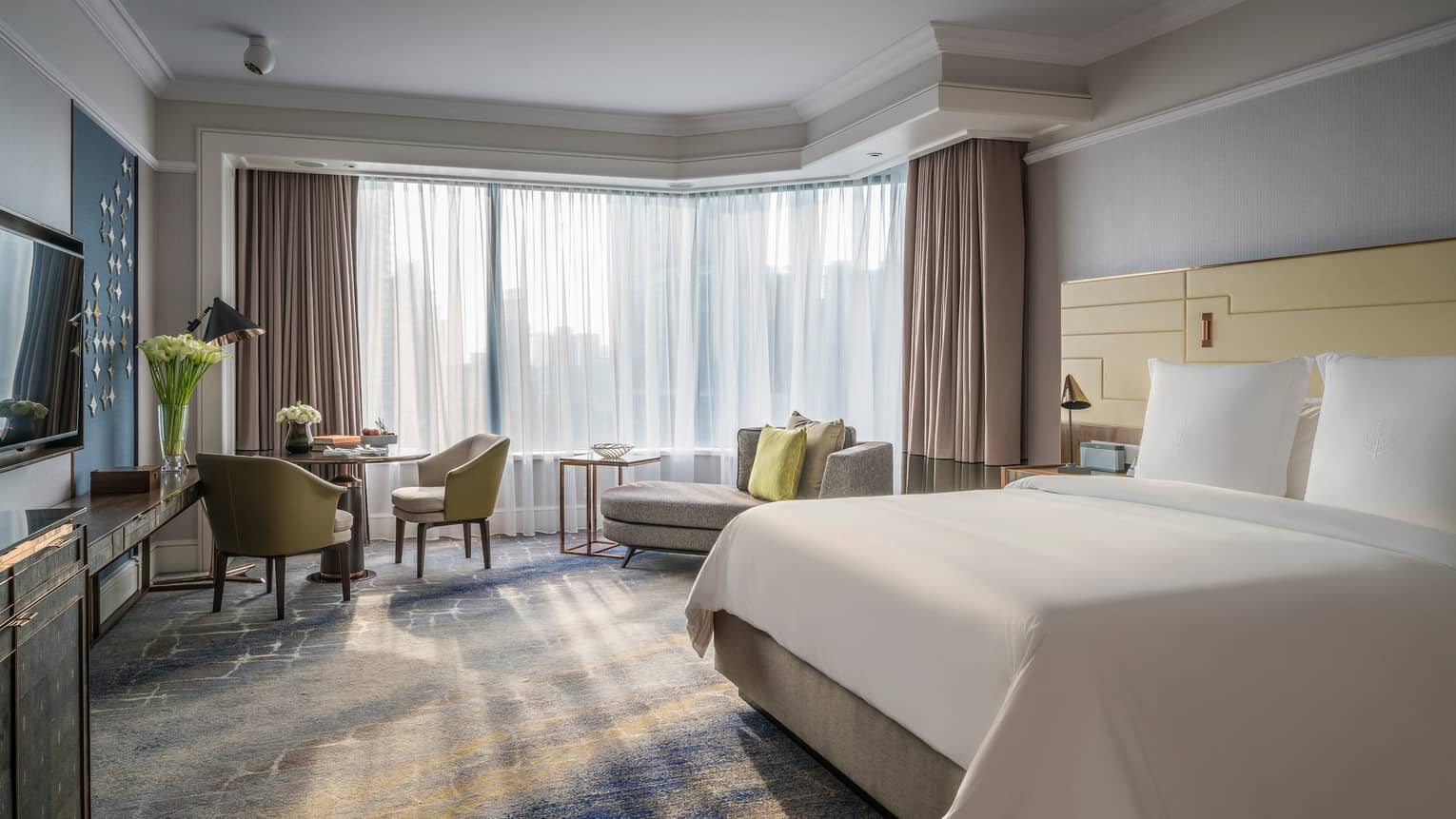 Luxury Accommodations And Rooms Singapore Four Seasons Sunny Deluxe Room Bed With White Linens Small Dining Table And Chaise Lounge