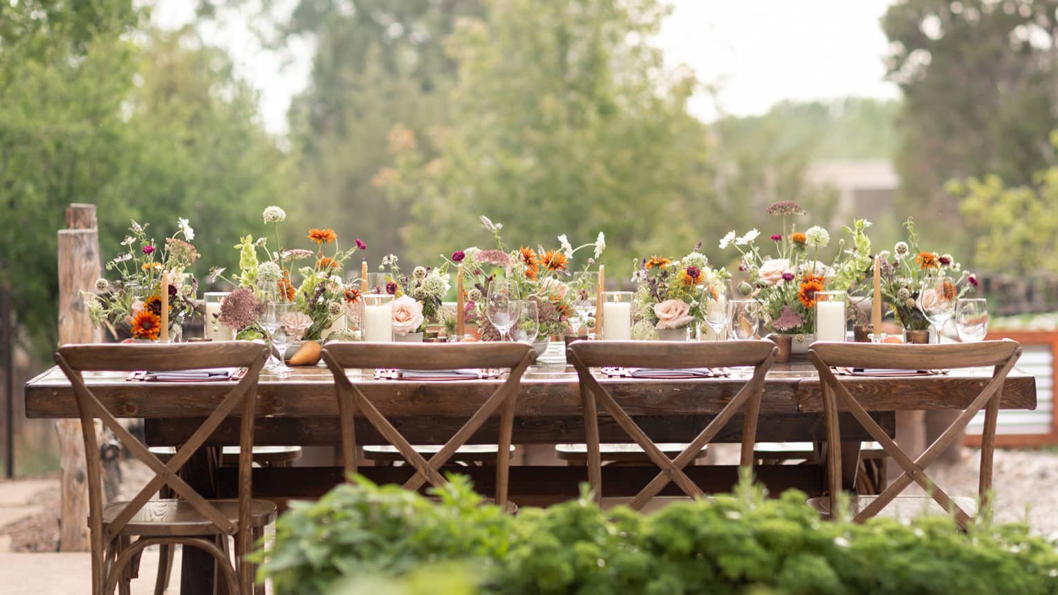 A table outside covered in flowers.