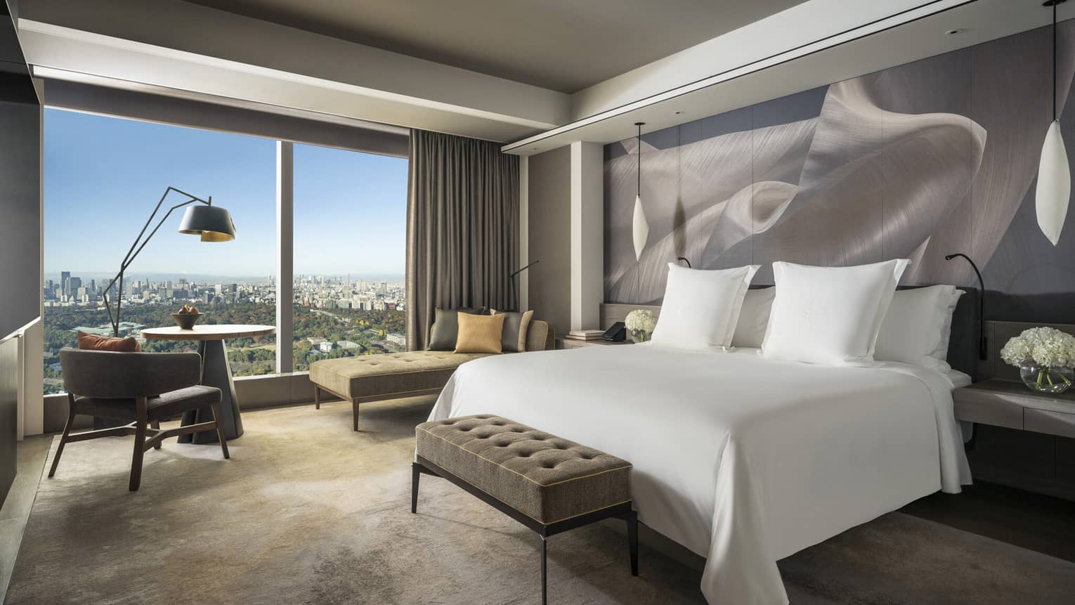 ,Hotel room with king bed, chaise, table and two chairs, and large wall window,,Hotel room with king bed, chaise, table and two chairs, and large wall window