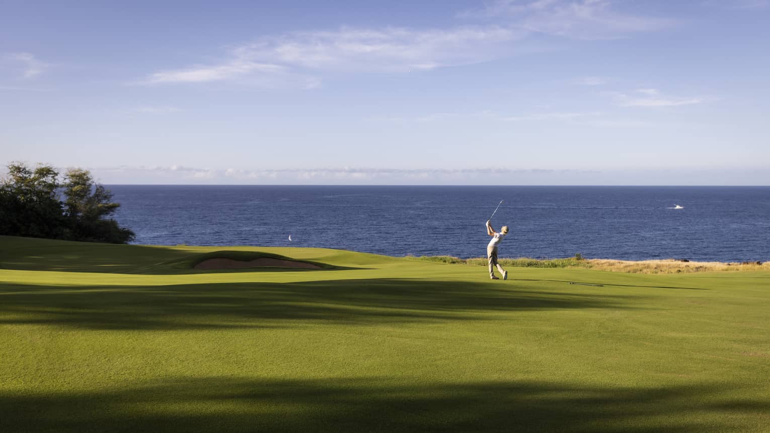 Golfer on oceanside fairway at Four Seasons Resort Lanai