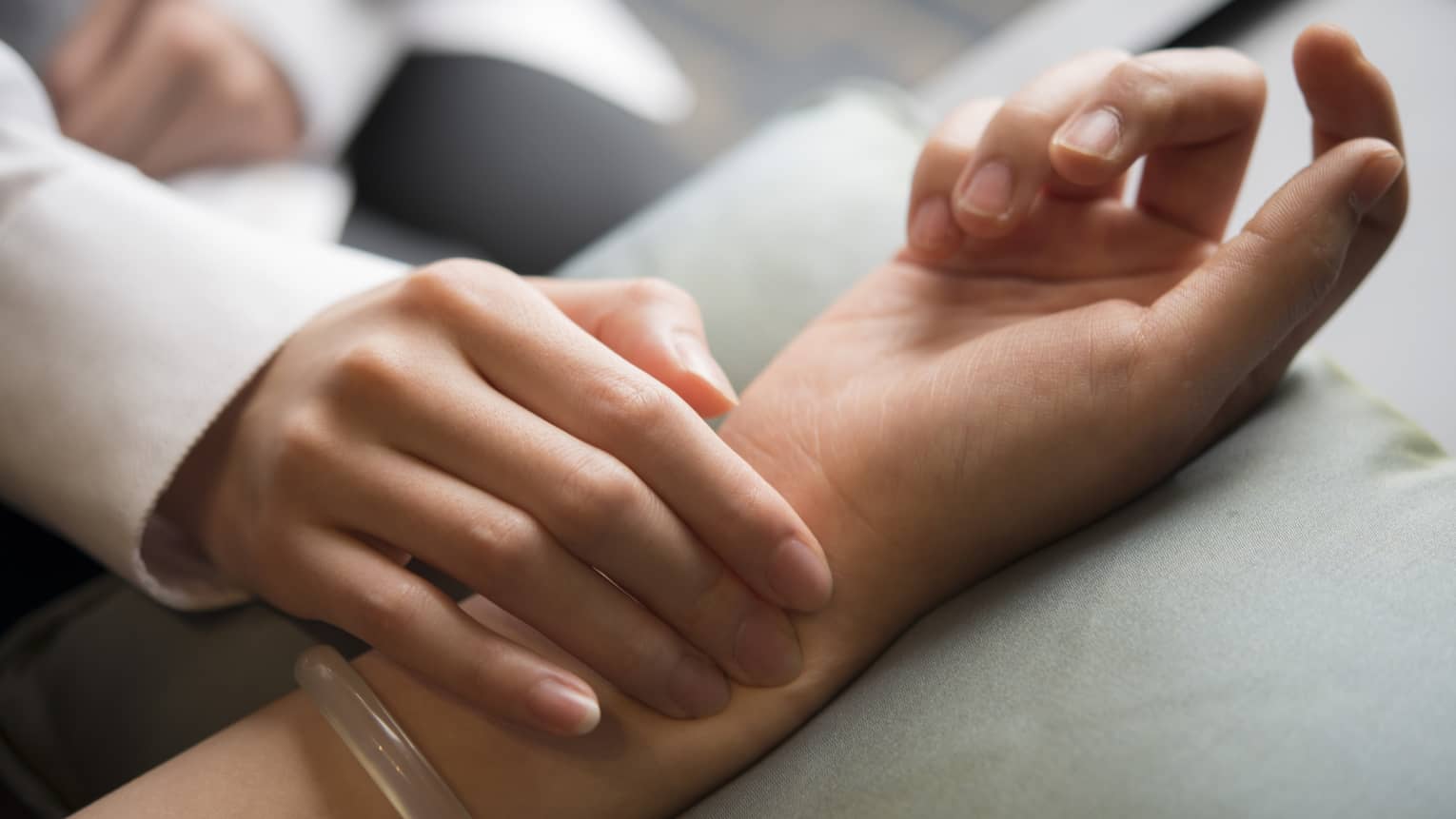 Hand placed on wrist in spa