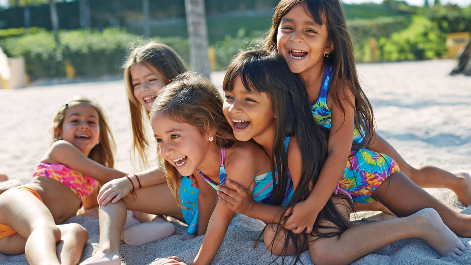 A group of kids playing at a beach.