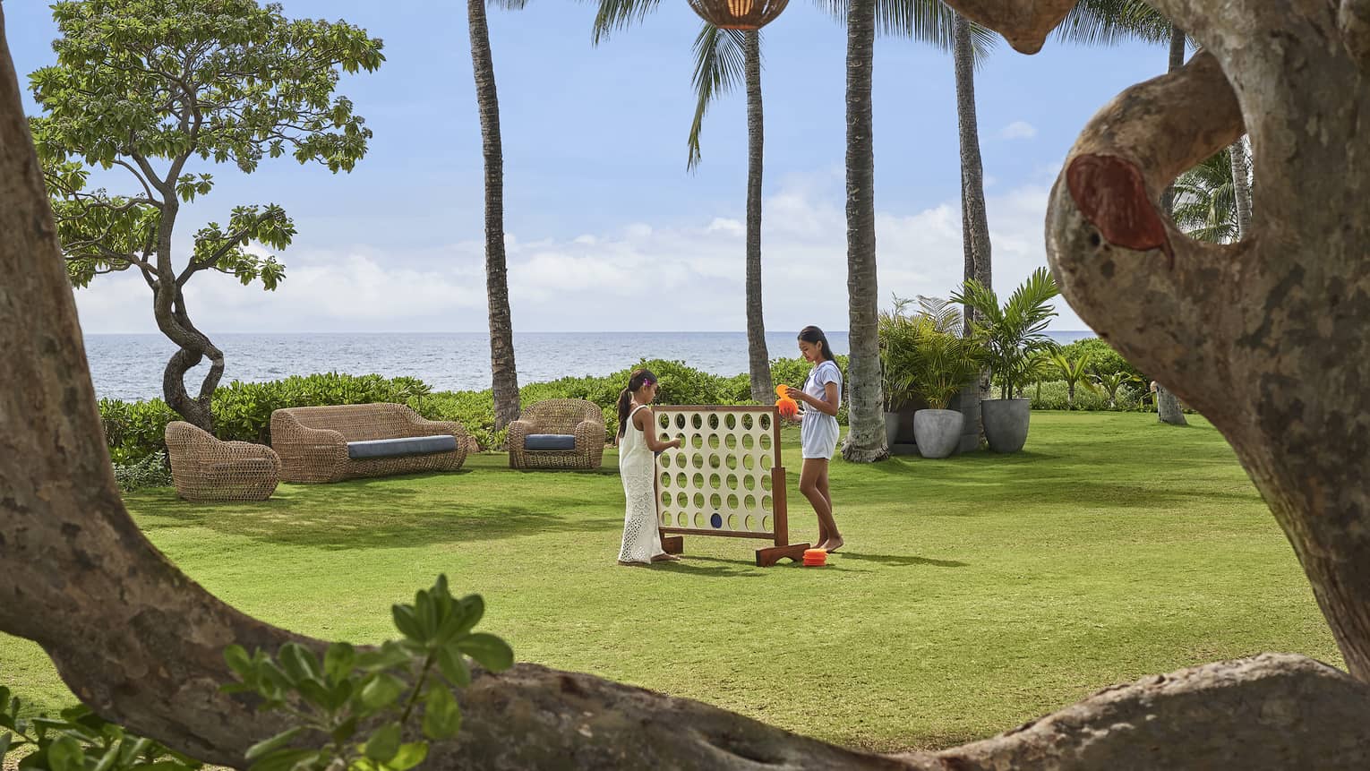 Two sisters play oversized Connect Four on the Resort lawn