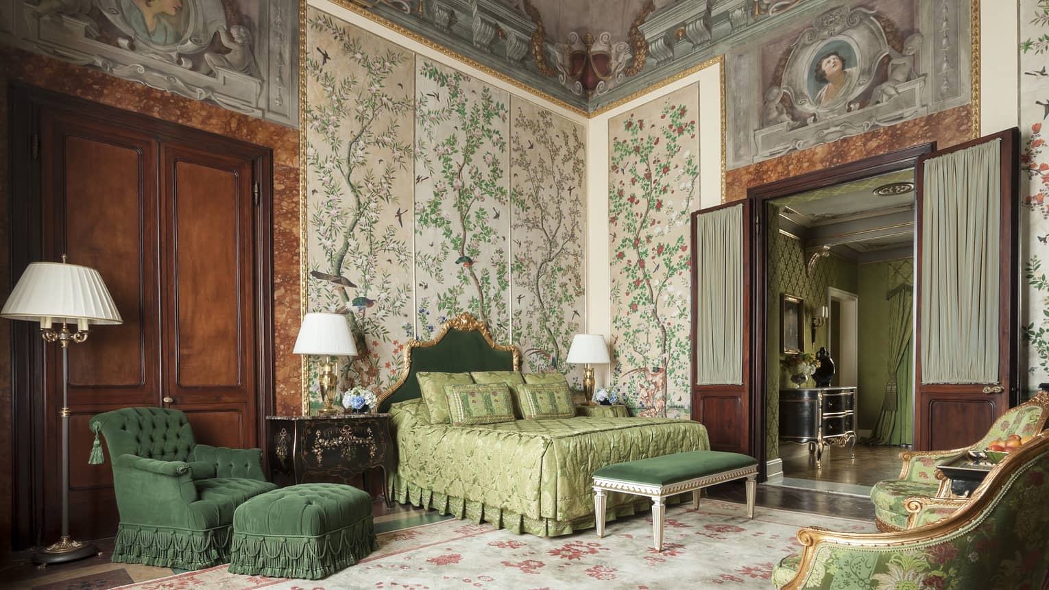 Hotel suite with elaborate wall paper and fresco ceiling