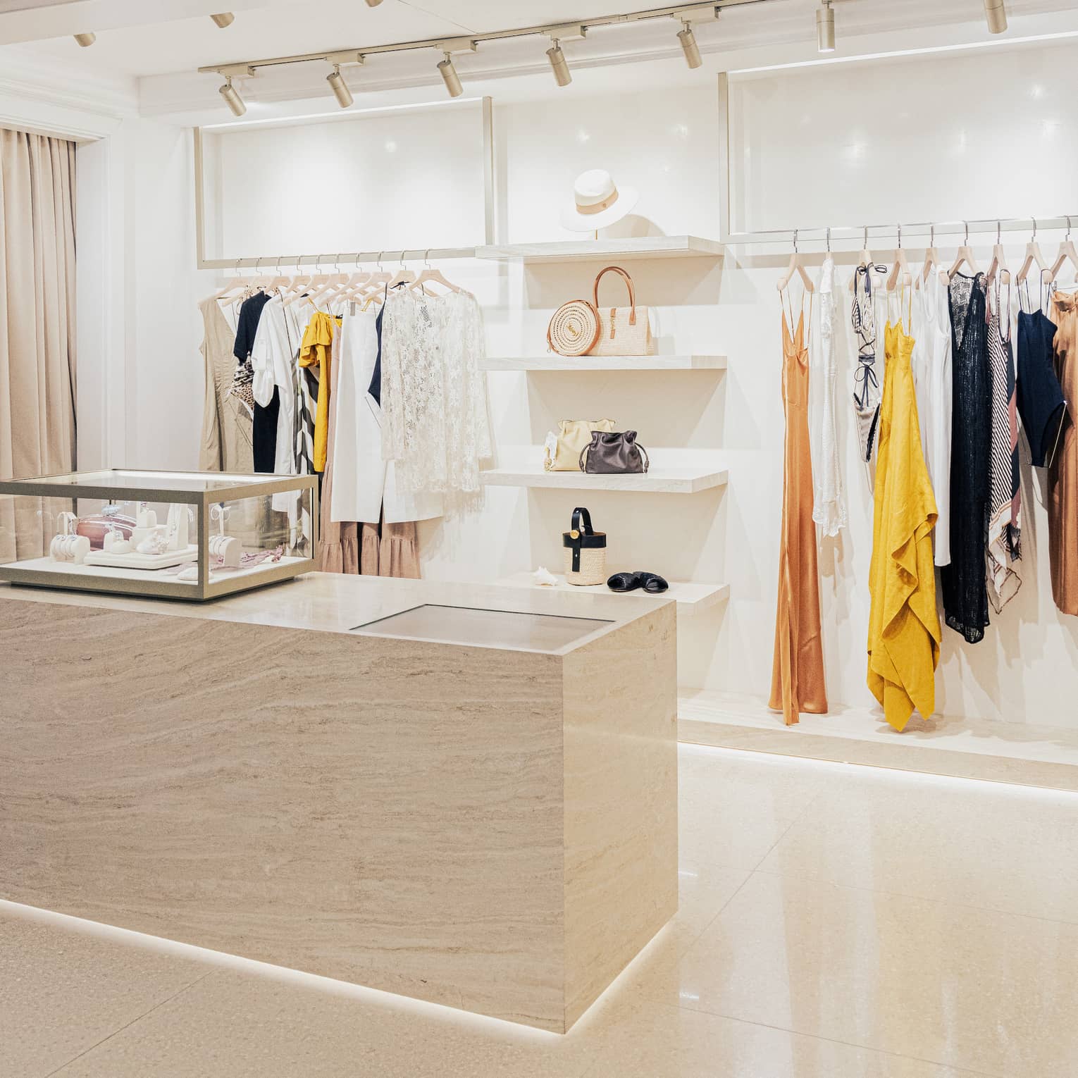 Contemporary boutique with white shelving and stylish clothes