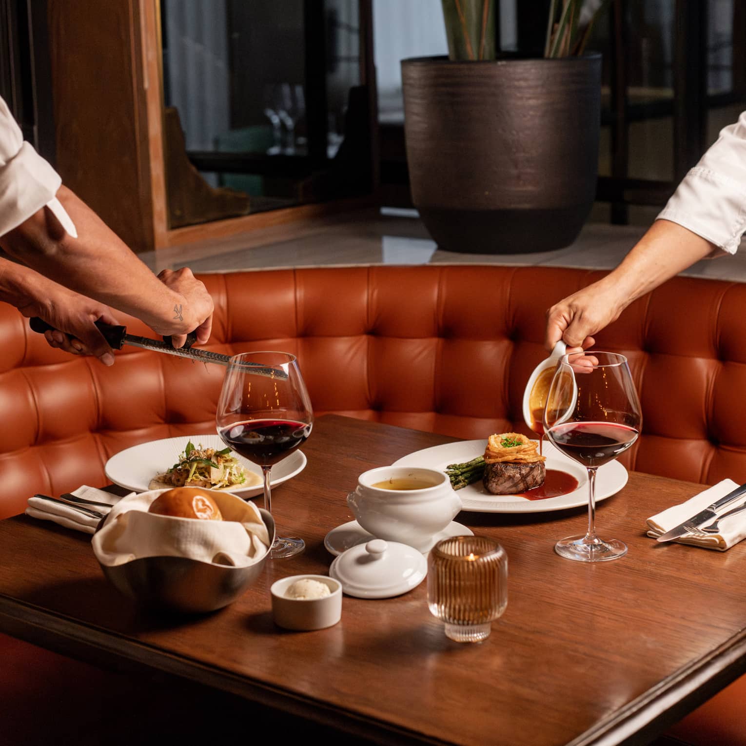 Servers' hands set table at Edge Brasserie 