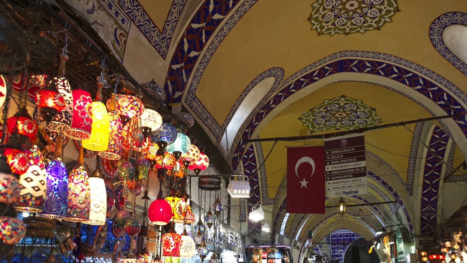 Grand Bazaar Spice Market with wall of colourful Turkish lanterns under mosaic ceiling