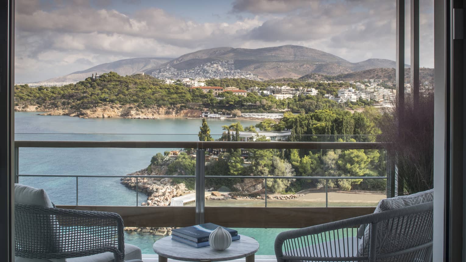 Four Seasons Astir Palace Hotel Athens balcony chairs, table with books, overlooking sea, trees, mountains