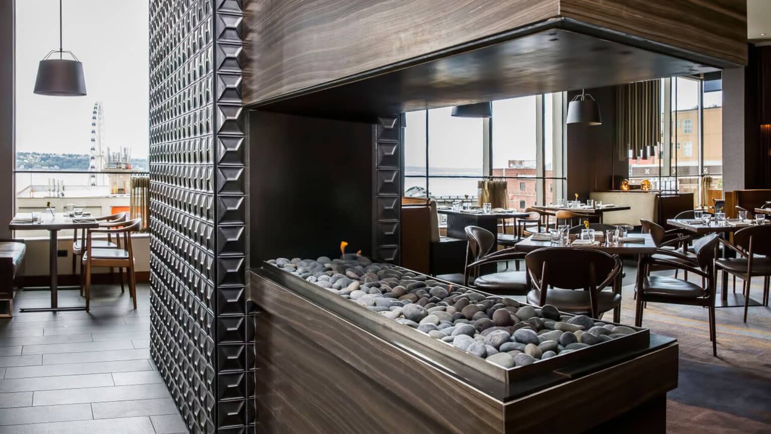 Goldfinch Tavern wood gas fireplace with stones, decorative metal wall, dining room