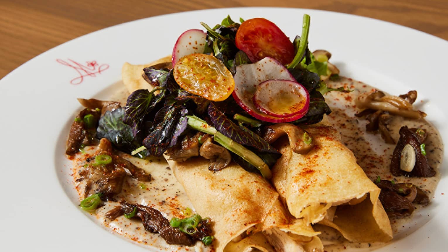 A breakfast dish on a plate with toppings of vegetables