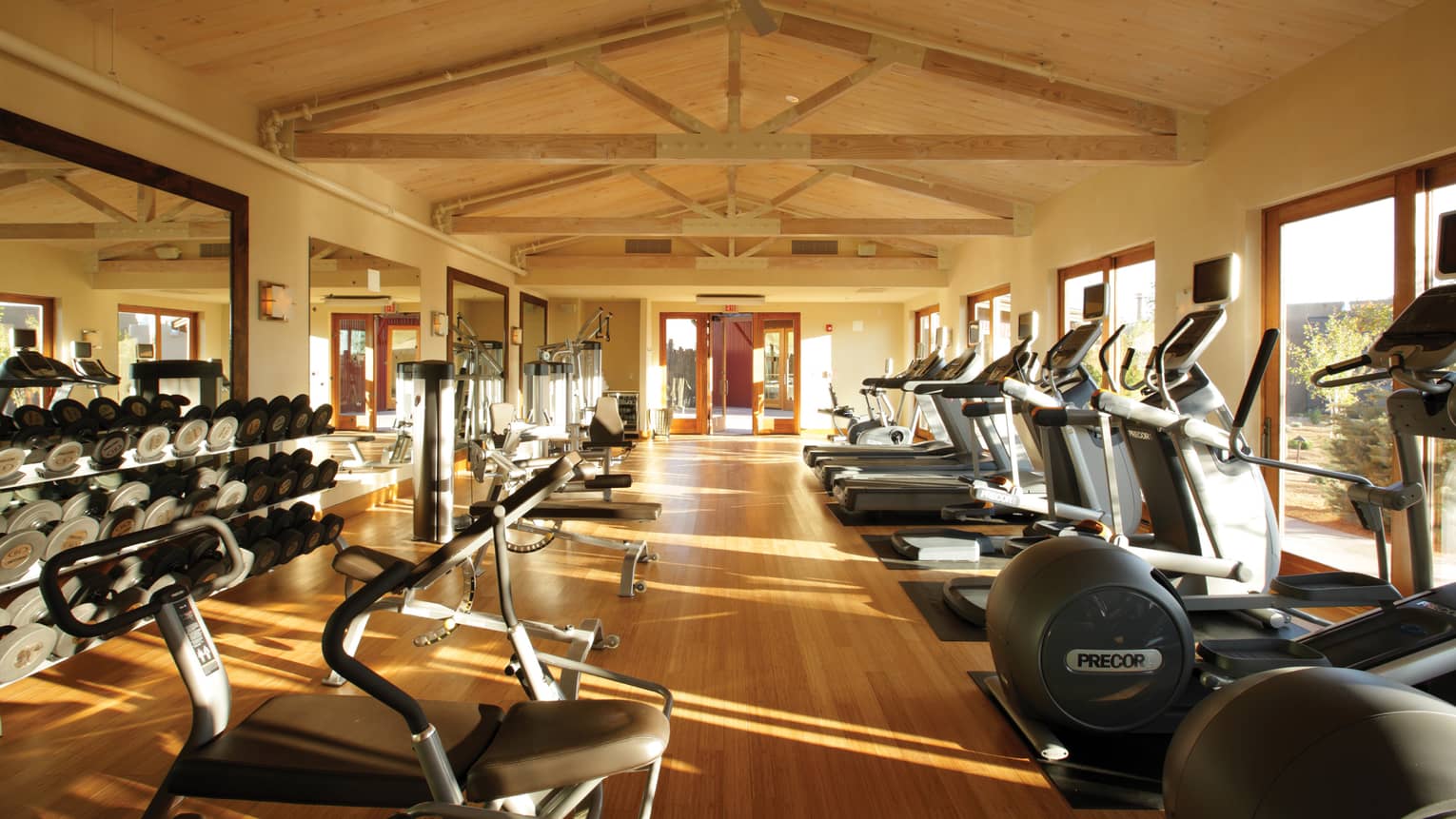 Treadmills, cardio equipment, weights under cathedral ceilings in Fitness Centre