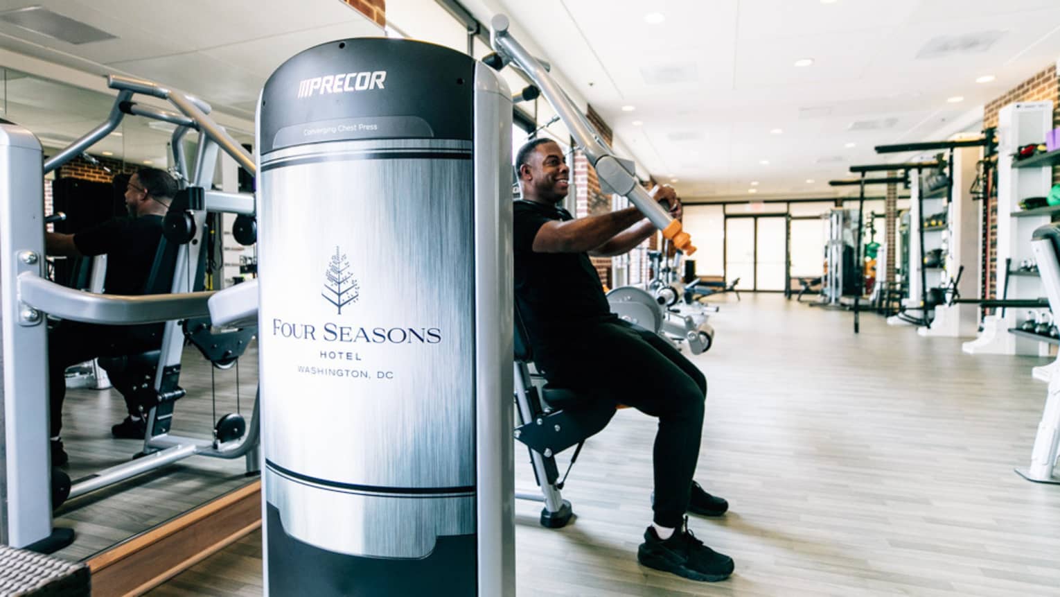 A man uses an arm press at the Four Seasons gym