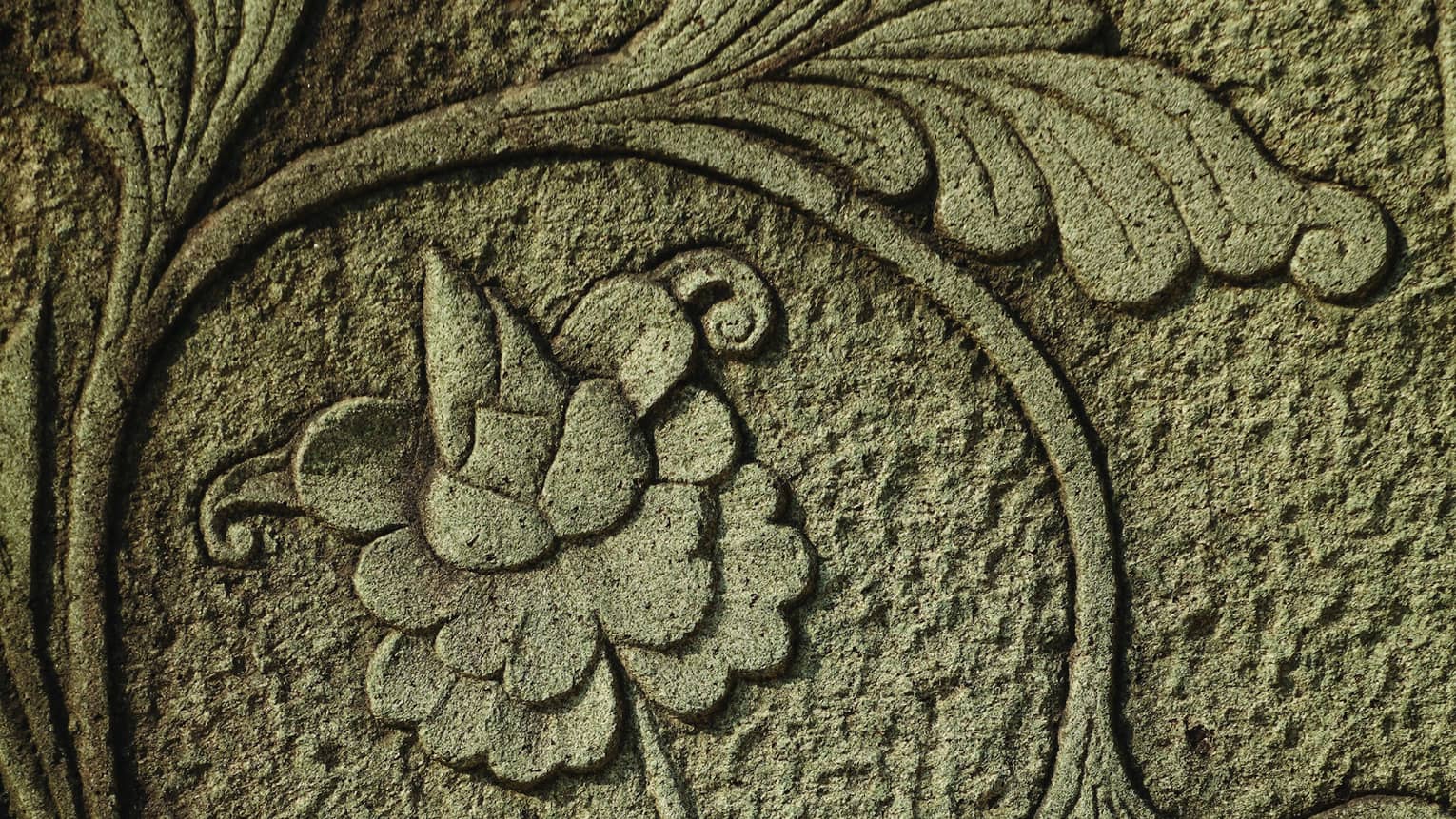 Intricate flowers and vines carved into concrete