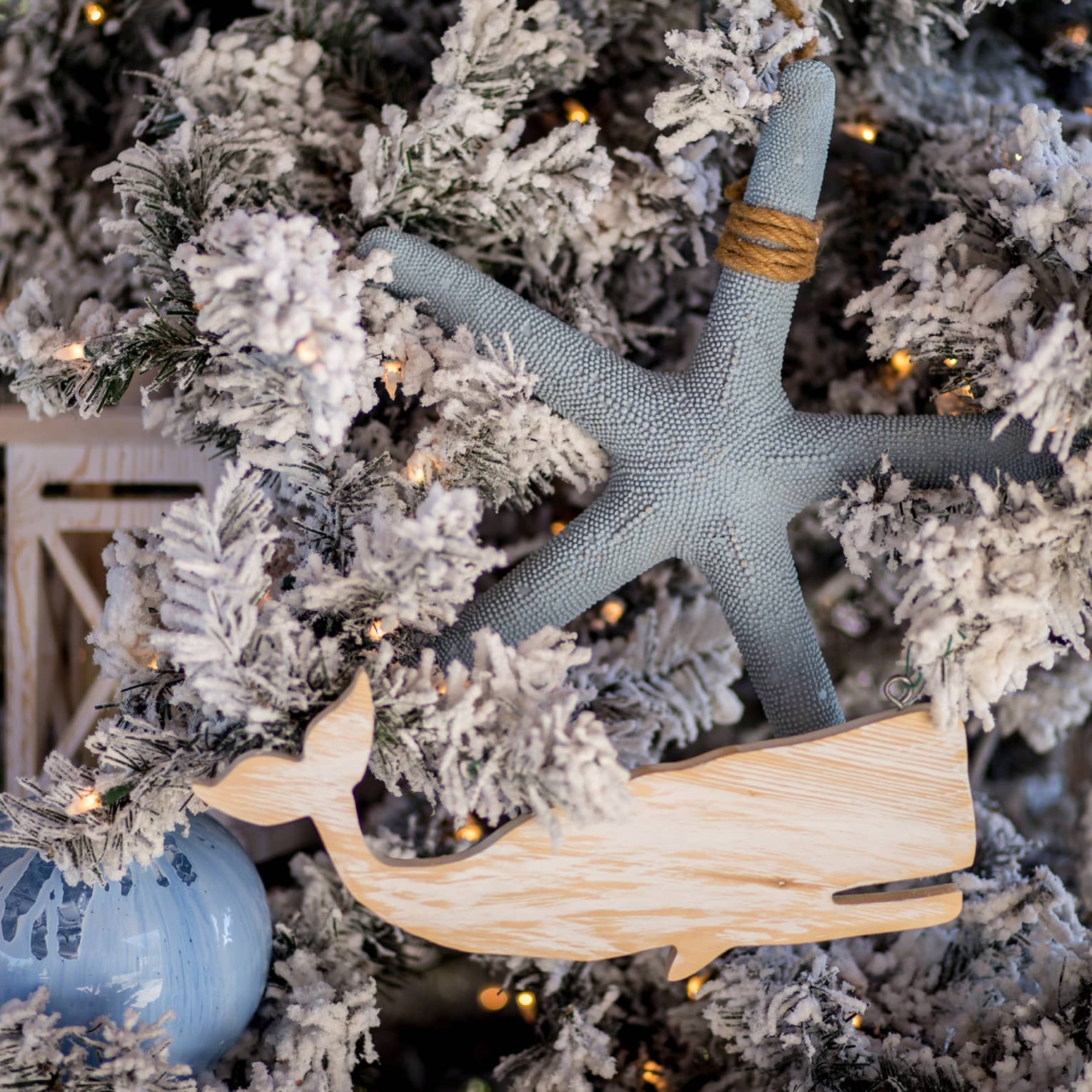 Christmas tree detailing, including a wooden whale and starfish decoration