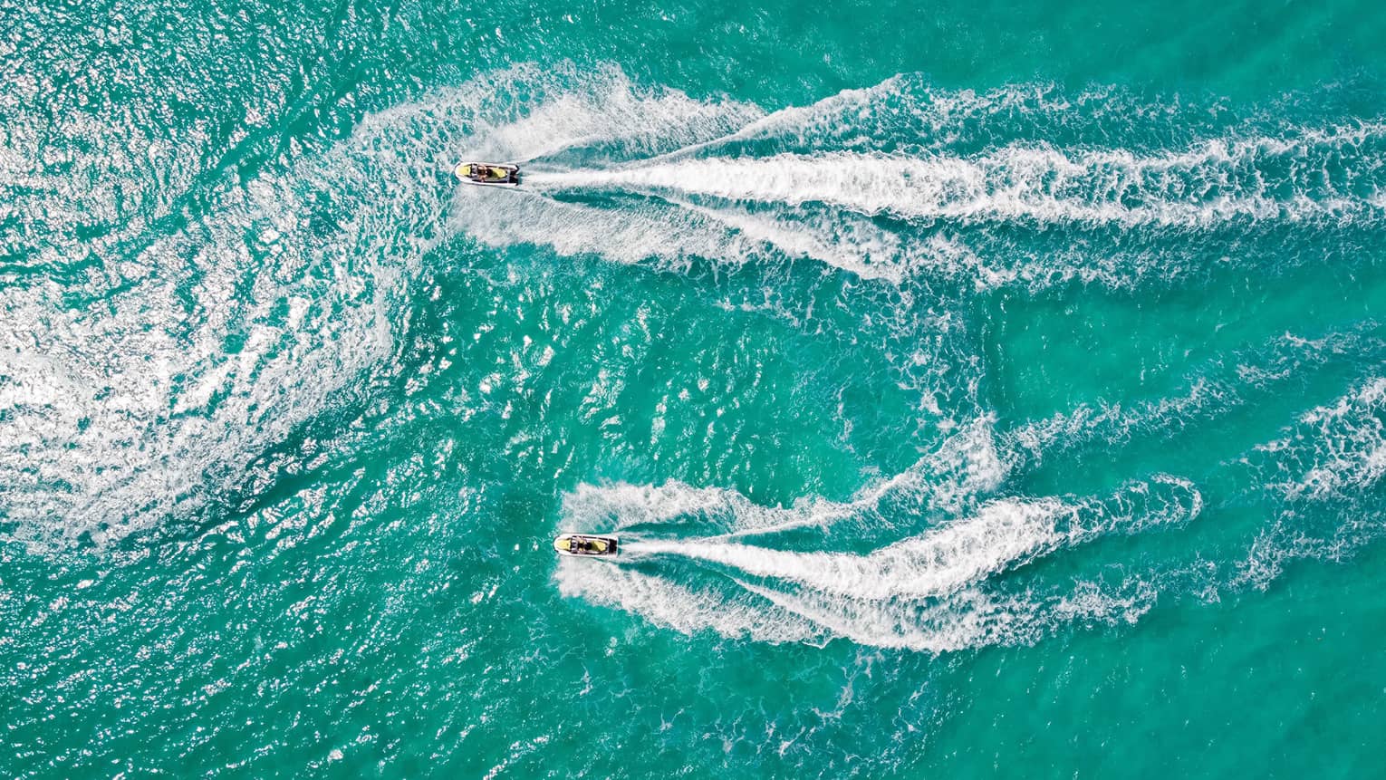 Aerial view of two people on jet skis