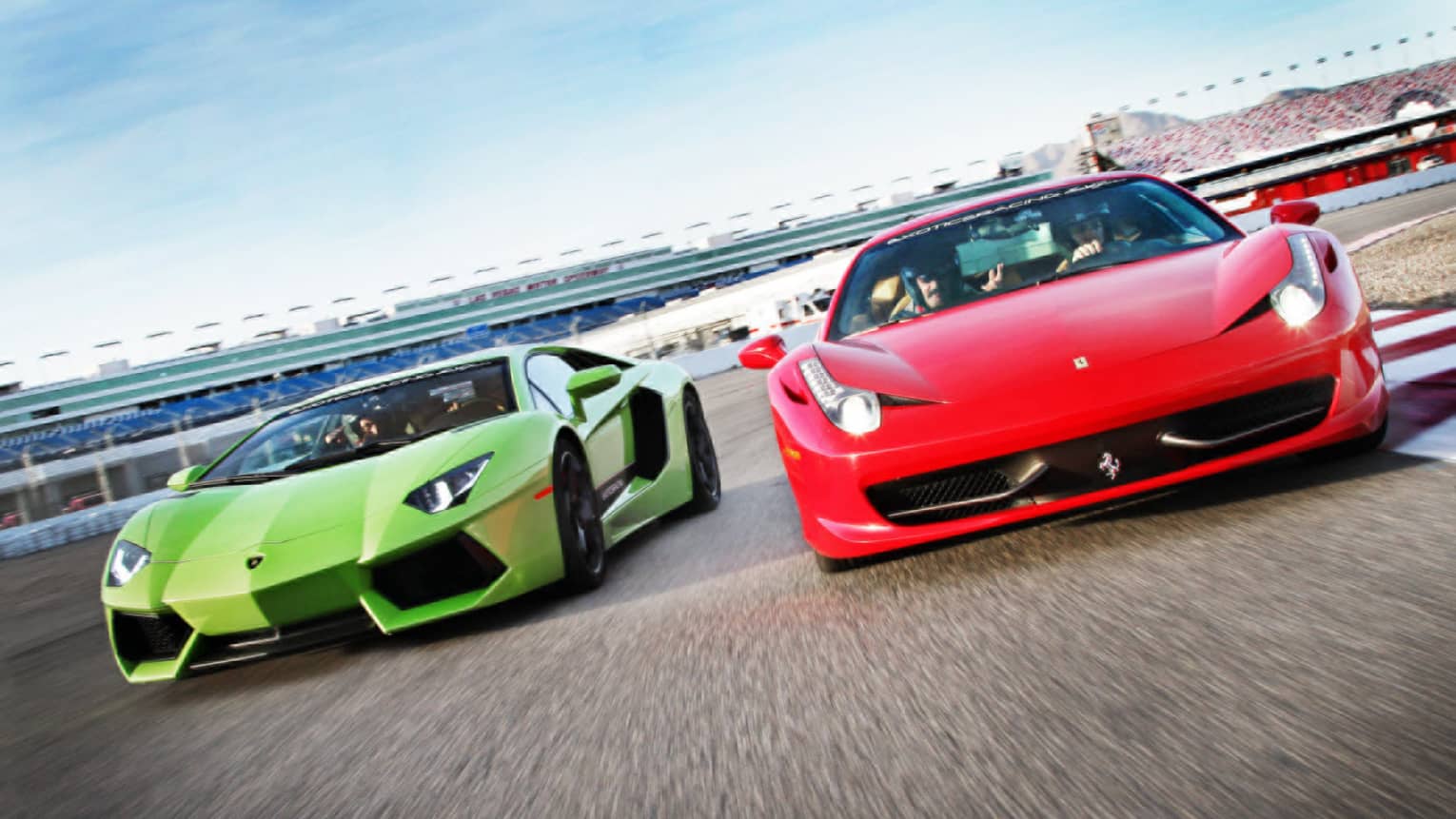 Red and green sports cars on race track