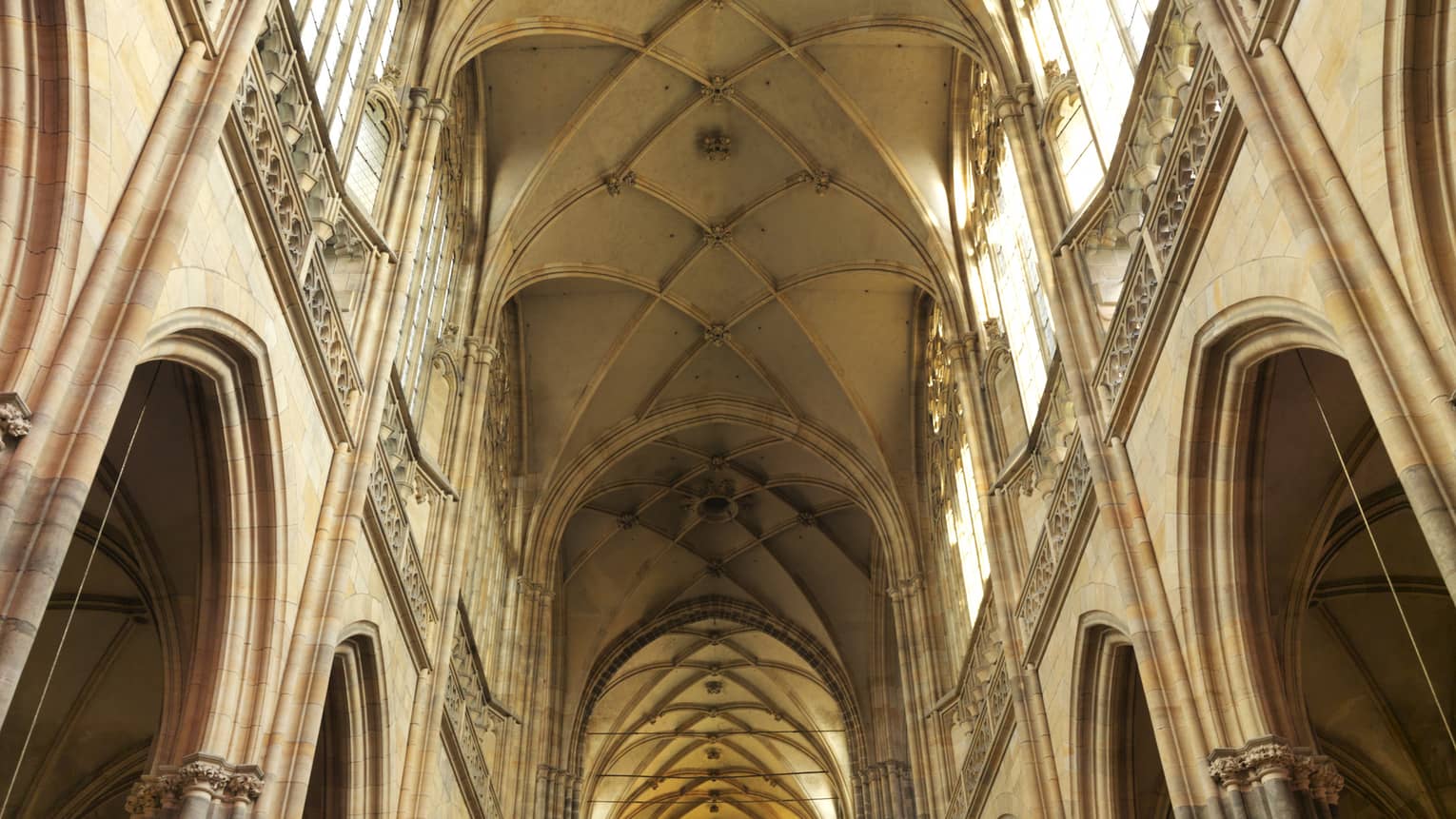 The inside of an ornate building with tall ceilings, columns and stained glass windows