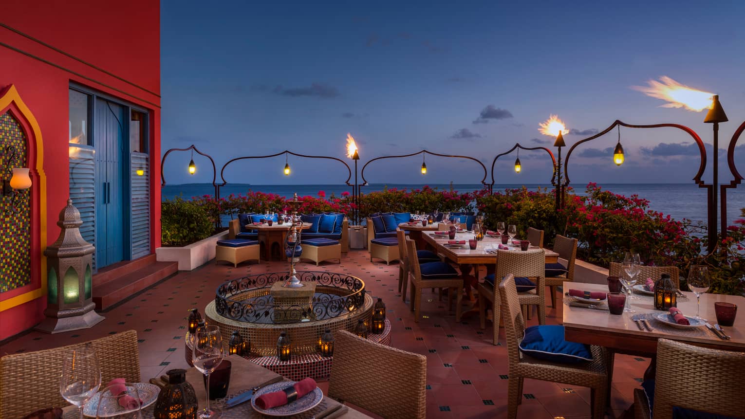 Al Barakat elegant rooftop shisha  bar with glowing lanterns, tile fountain, deep red and blue decor