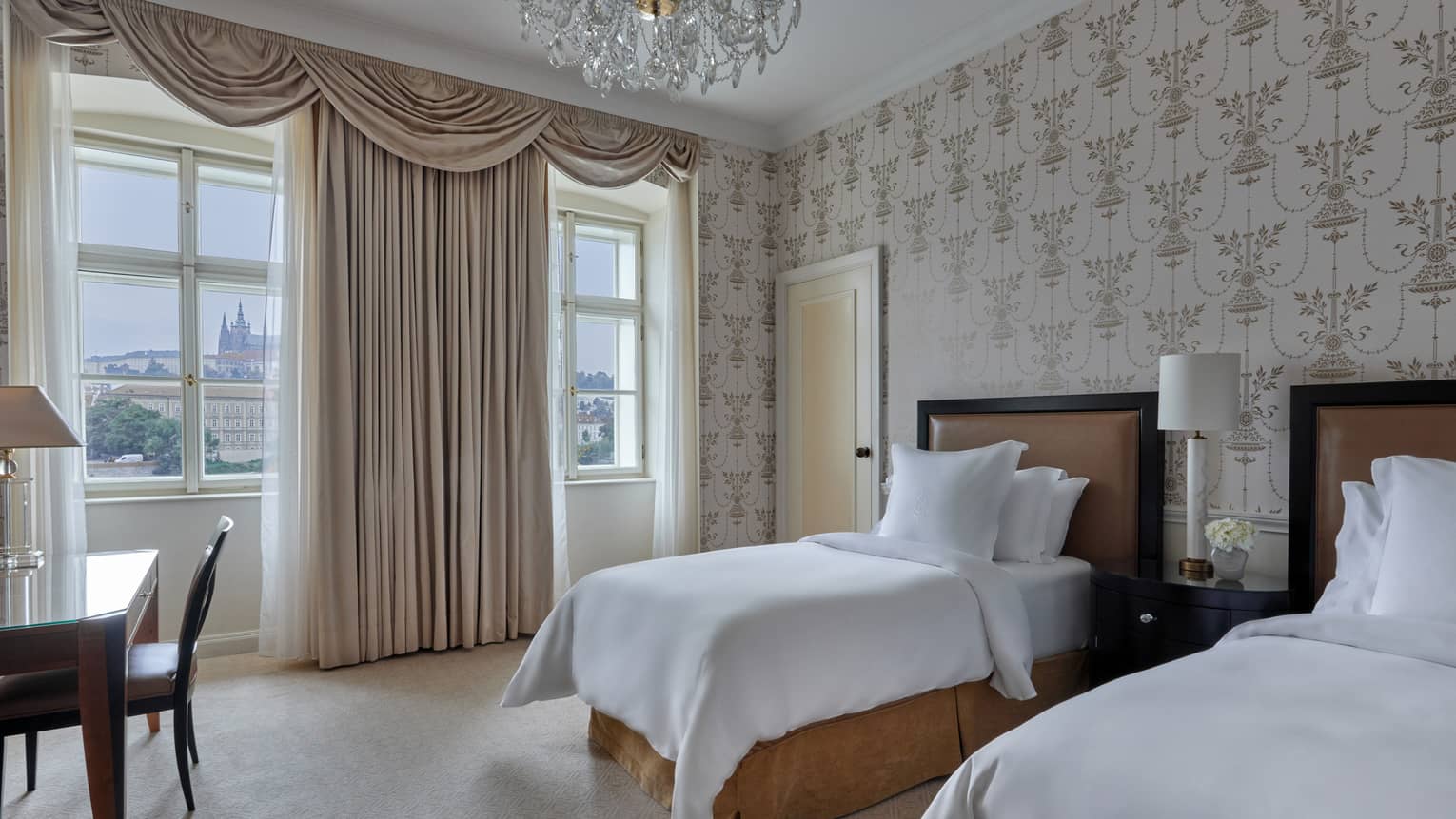 Hotel guest room with two twin beds, wall paper, elegant curtains