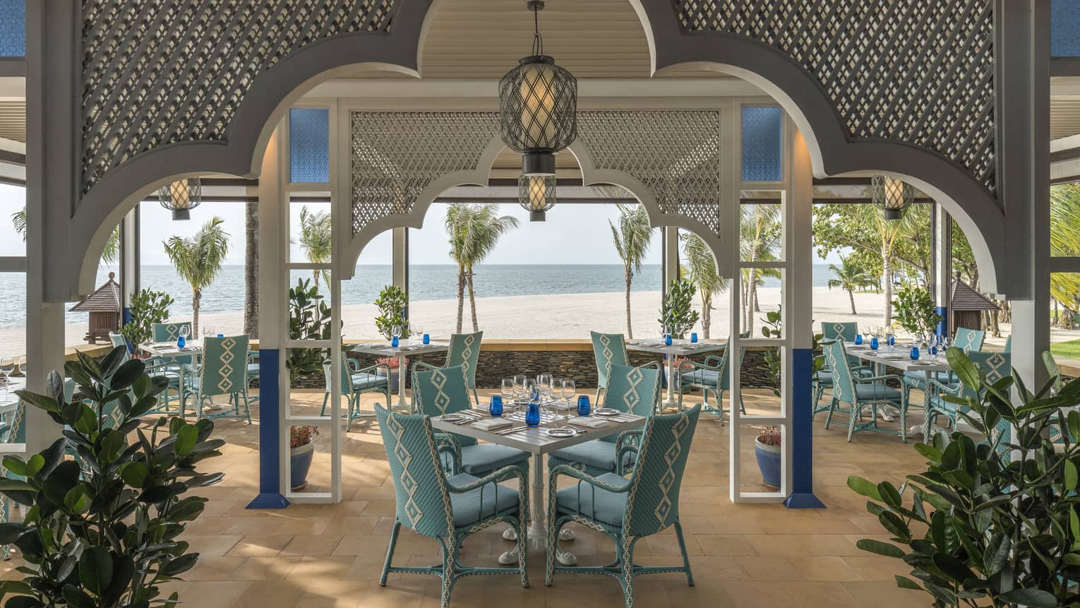 Upper Serai Restaurant dining area overlooking the beach with palm trees