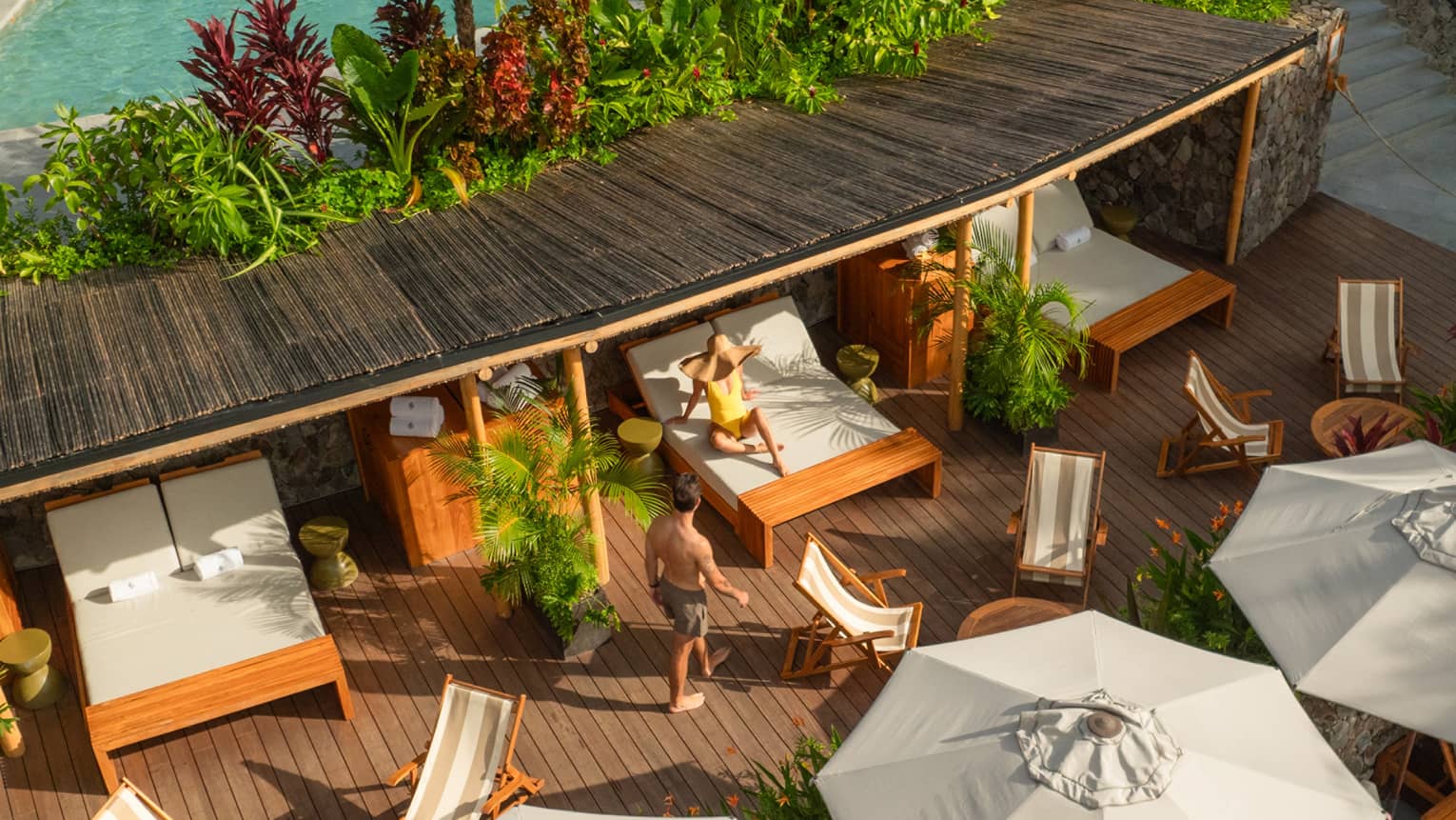 Aerial view of poolside cabanas and daybeds