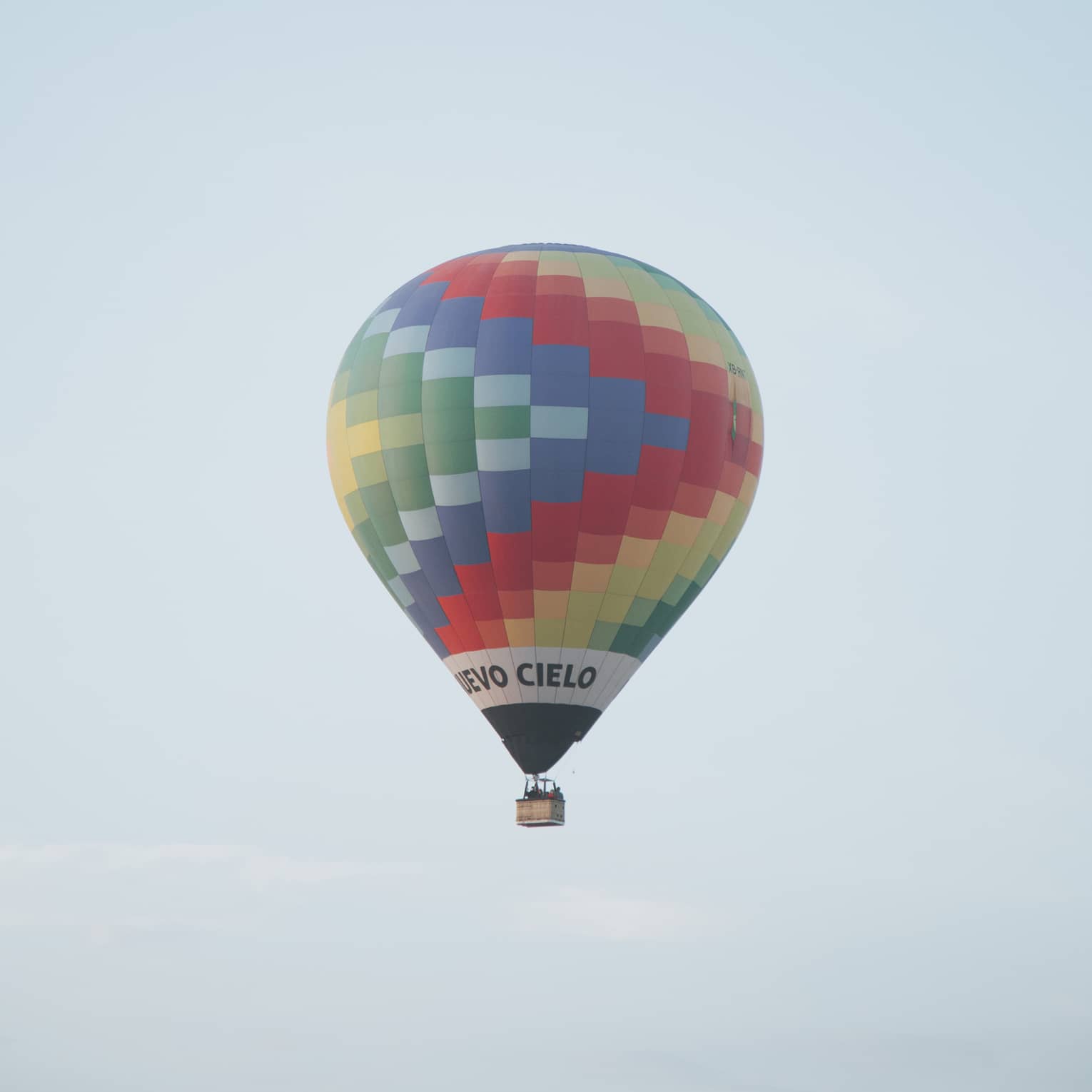 A hot air ballon floating in the sky.