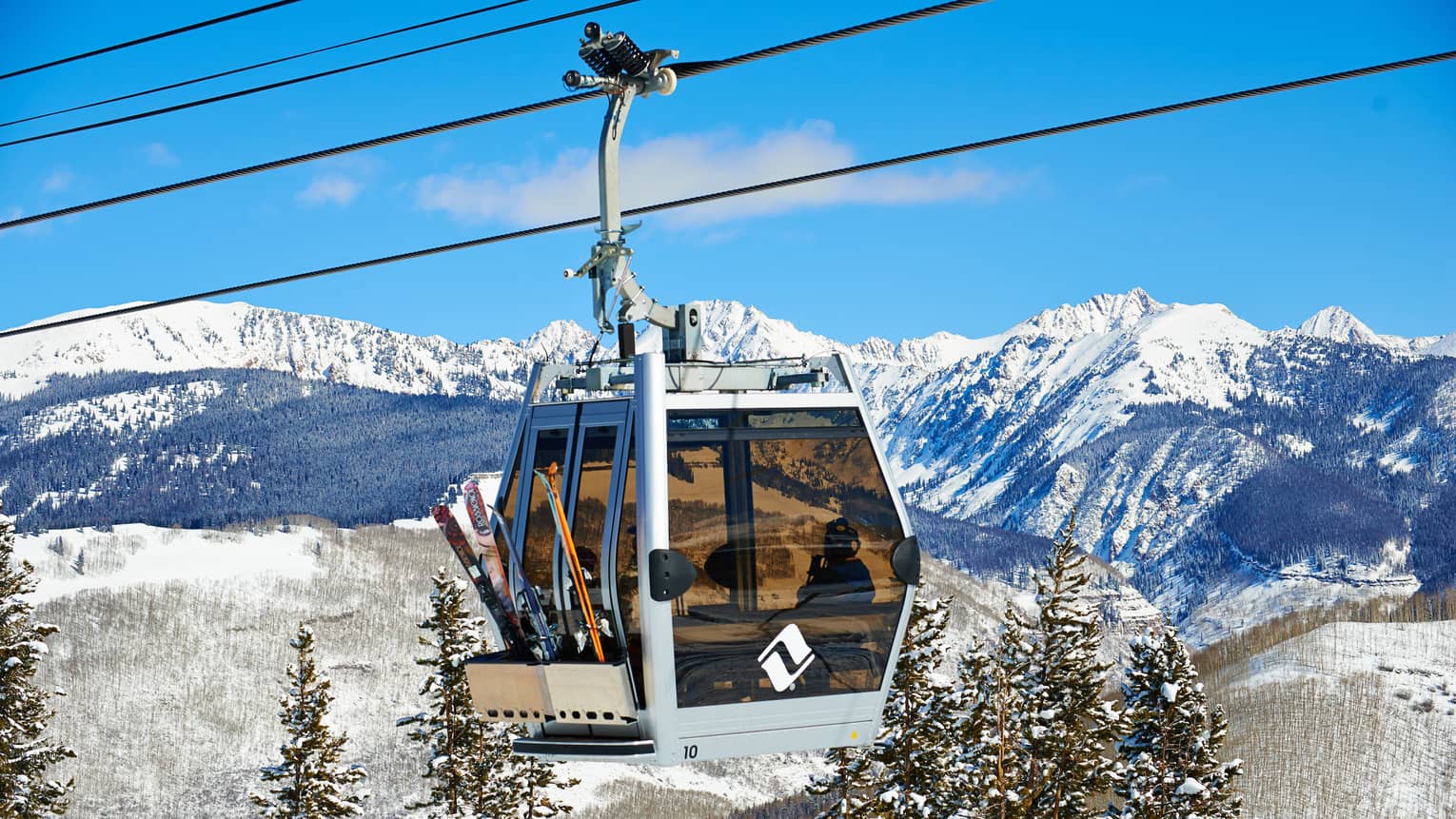 Ski lift heads uphill on snowy Vail, Colorado mountain