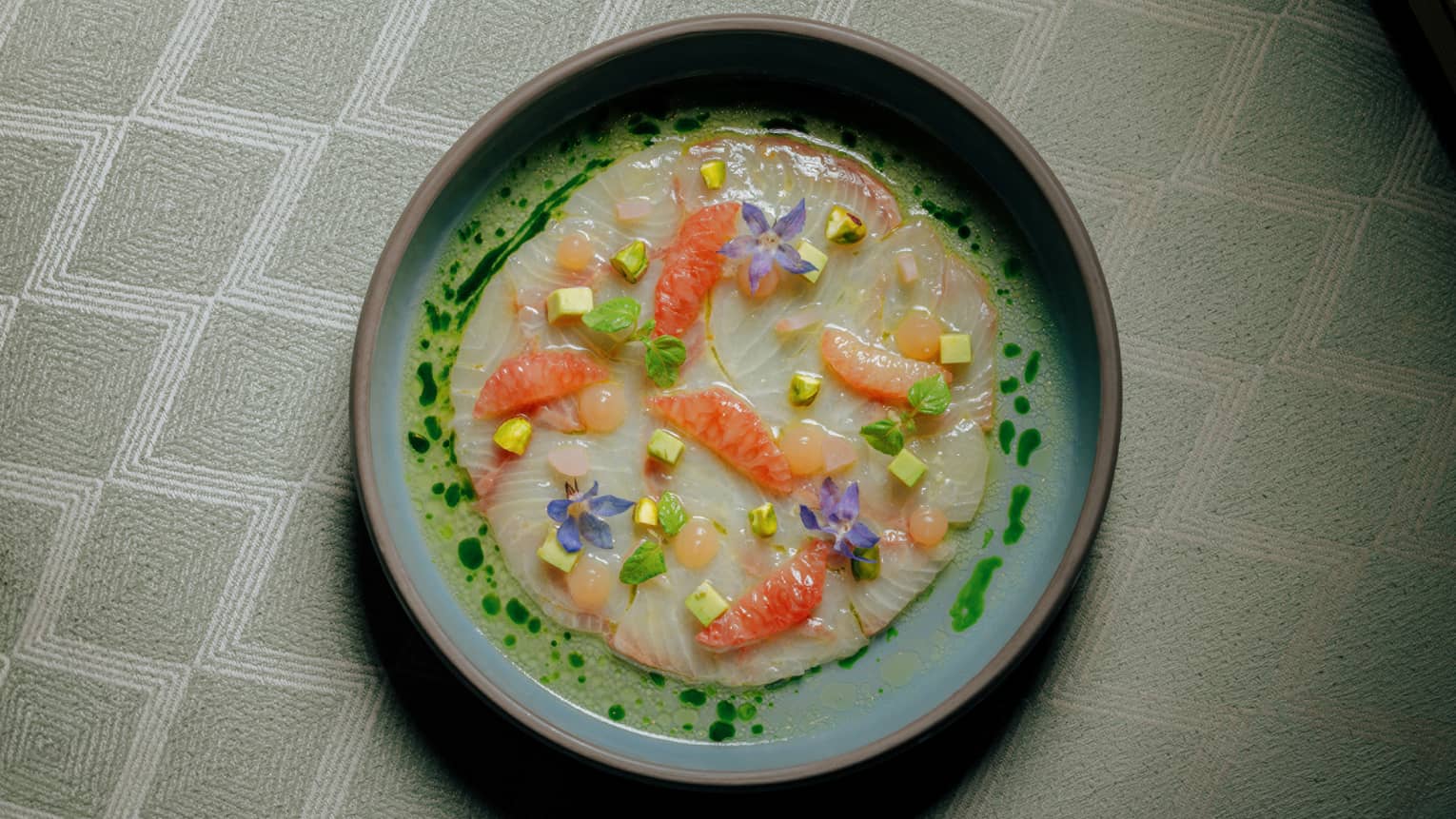 Amberjack Carpaccio served with Avocado, Grapefruit, Sicilian Pistachio and Ginger Vinaigrette
