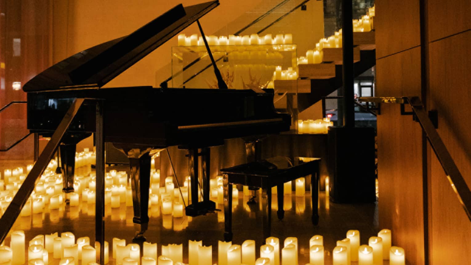 Grand piano surrounded by candles