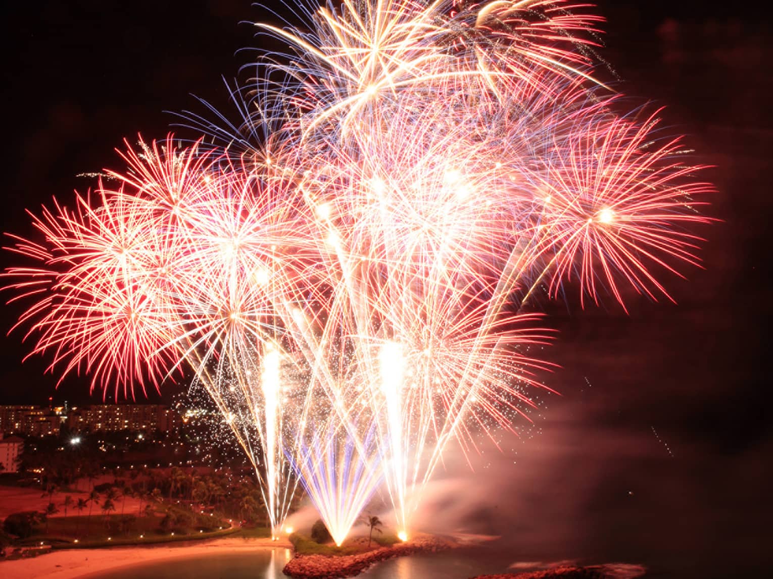 Red and yellow fireworks in a dark sky.