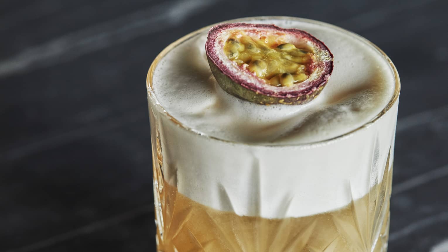 A cocktail in a glass with a fruit slice on top