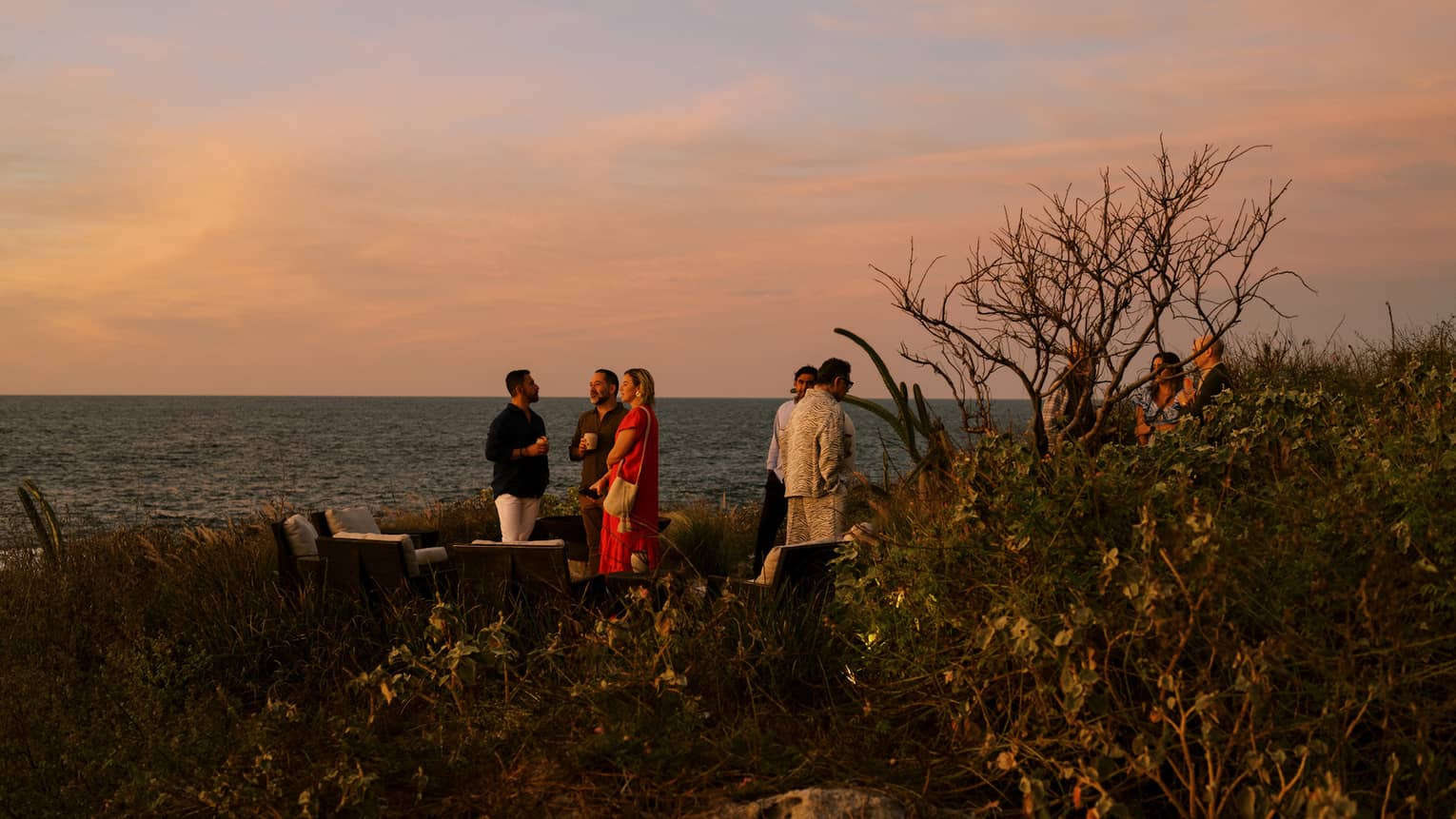 Group of guests mingling by the water