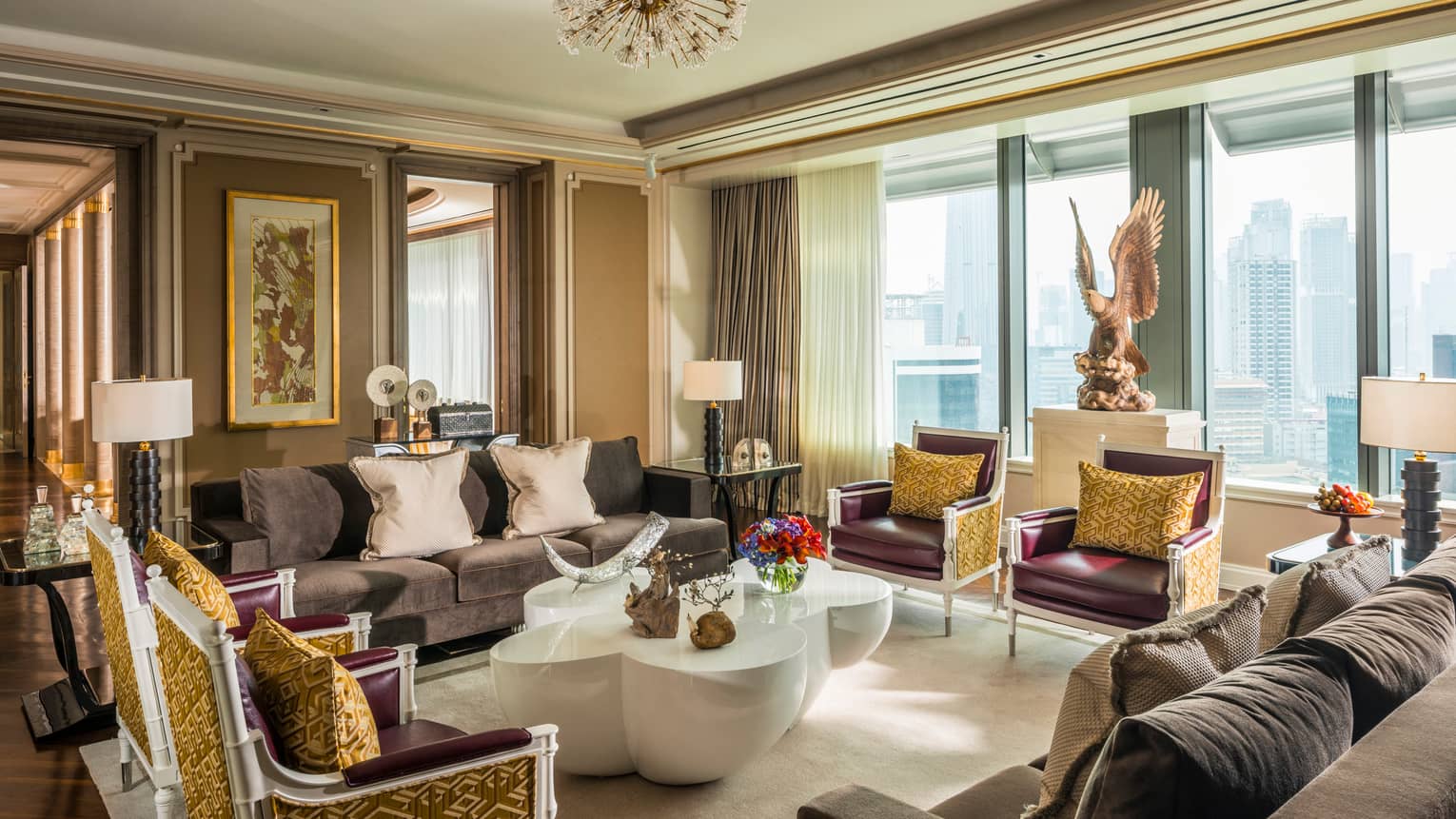Presidential Suite foyer with two sofas and four armchairs with accent pillows, large modern white coffee table, large eagle statue