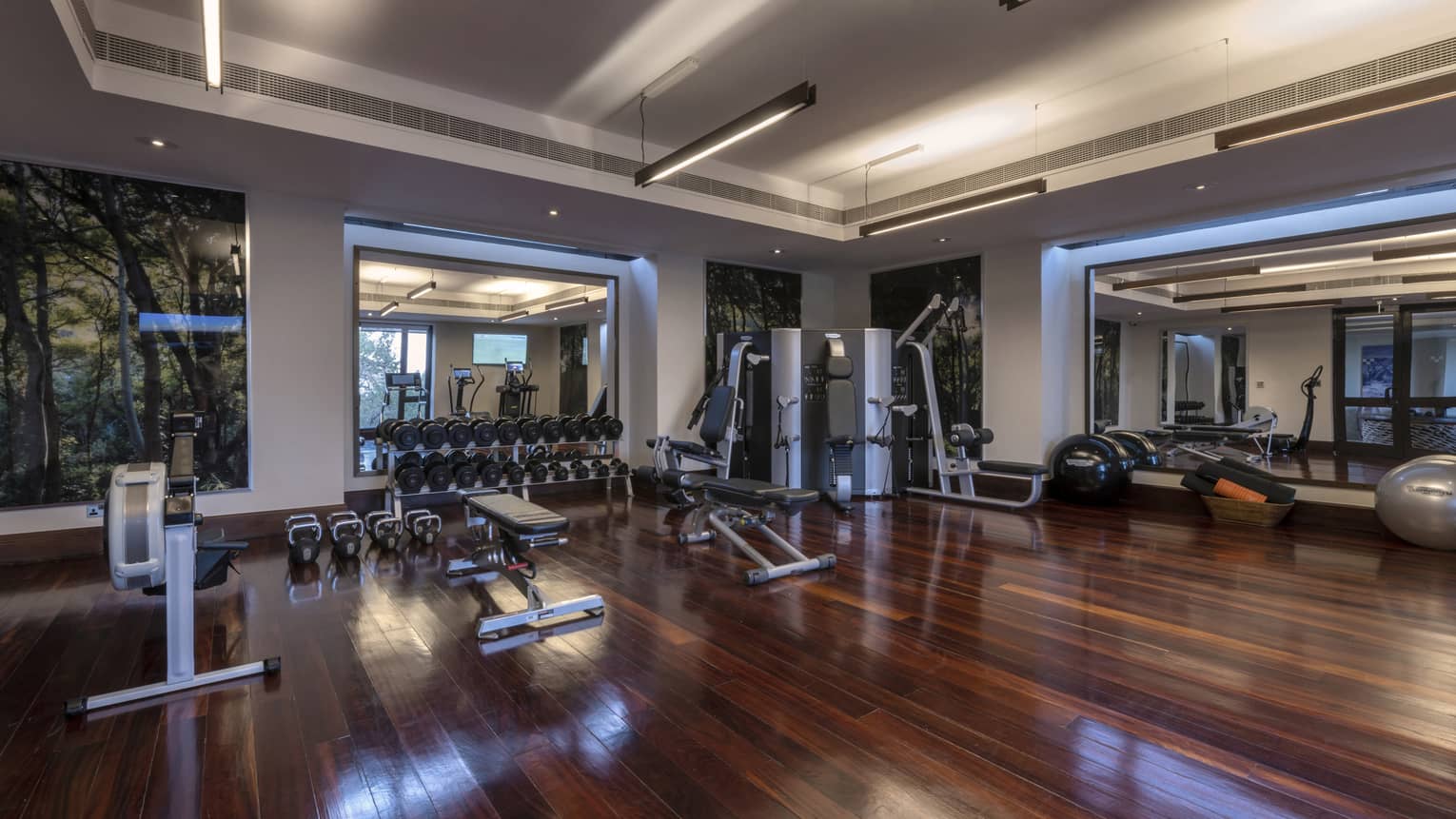 Large Fitness Centre with hardwood flooring, state-of-the-art equipment, tall windows and high ceilings