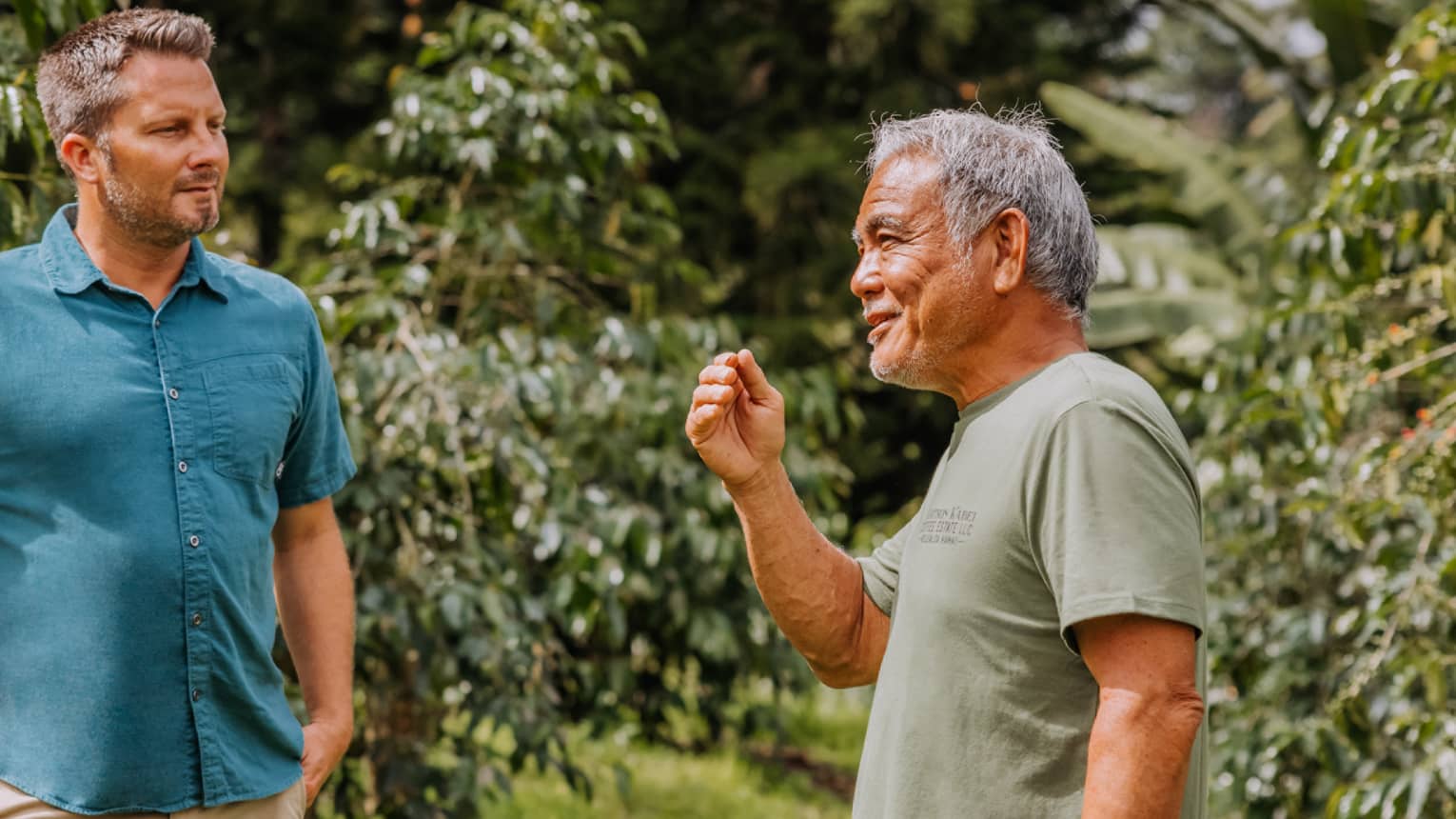 Coffee grower explains to tourist in detail the coffee-growing process