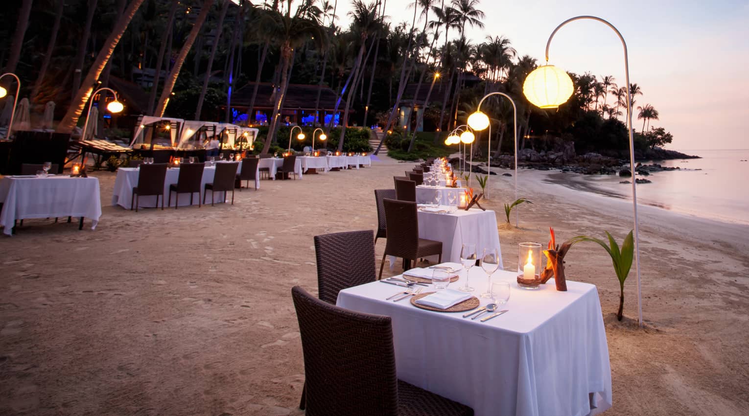 Barbecue on the beach with dining tables on the sand