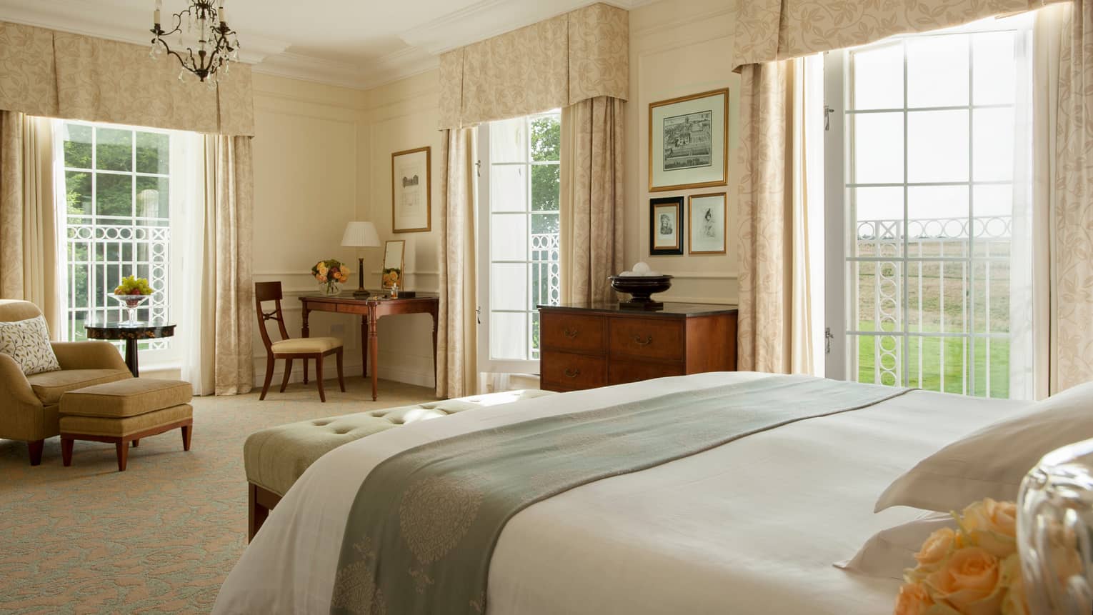 Belvedere Suite bed, plush bench, desk between corner windows with canopies