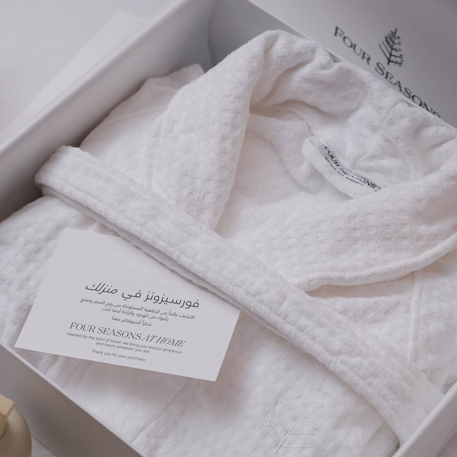White robe folded neatly in a box