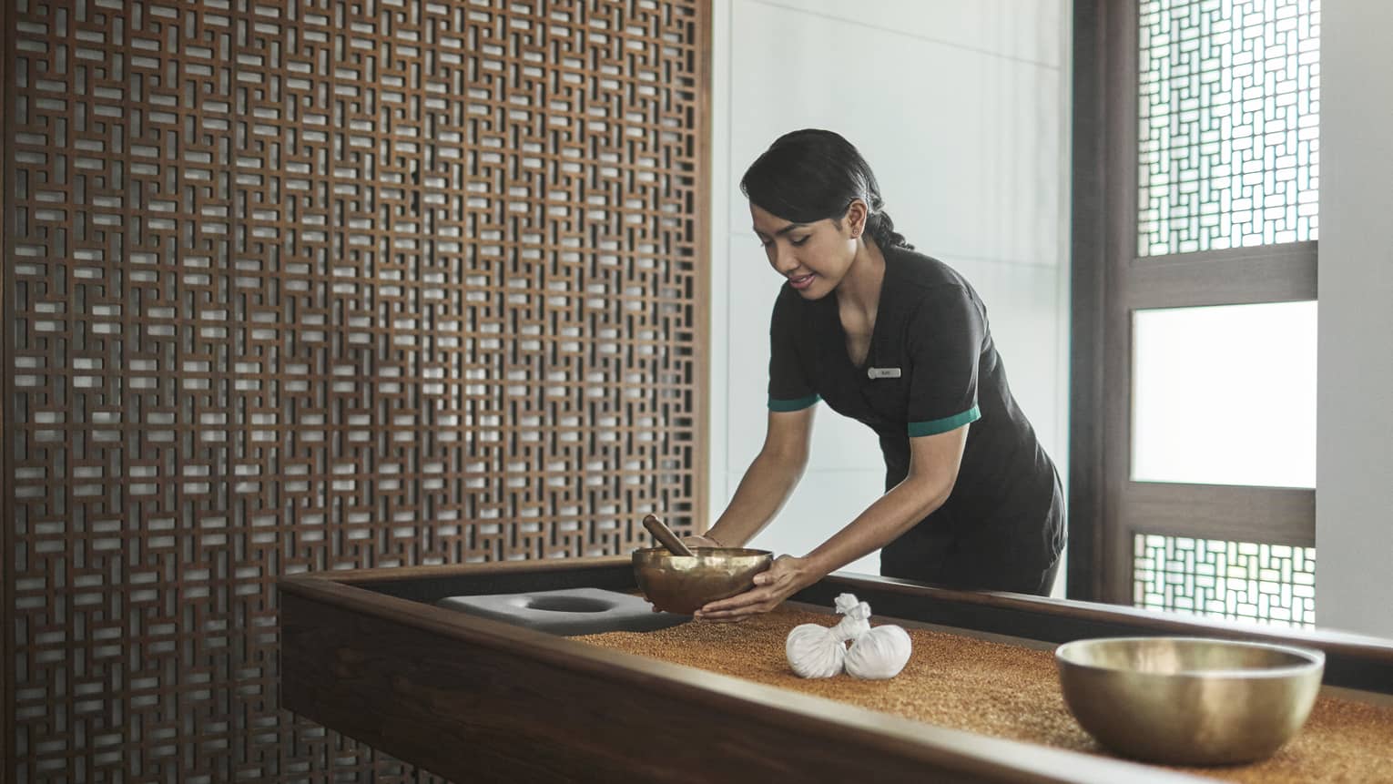 Pear Spa staff places copper bowl on table