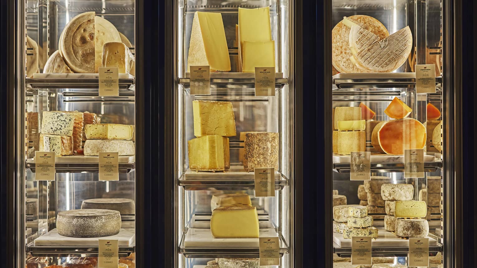 Three glass-walled cheese displays