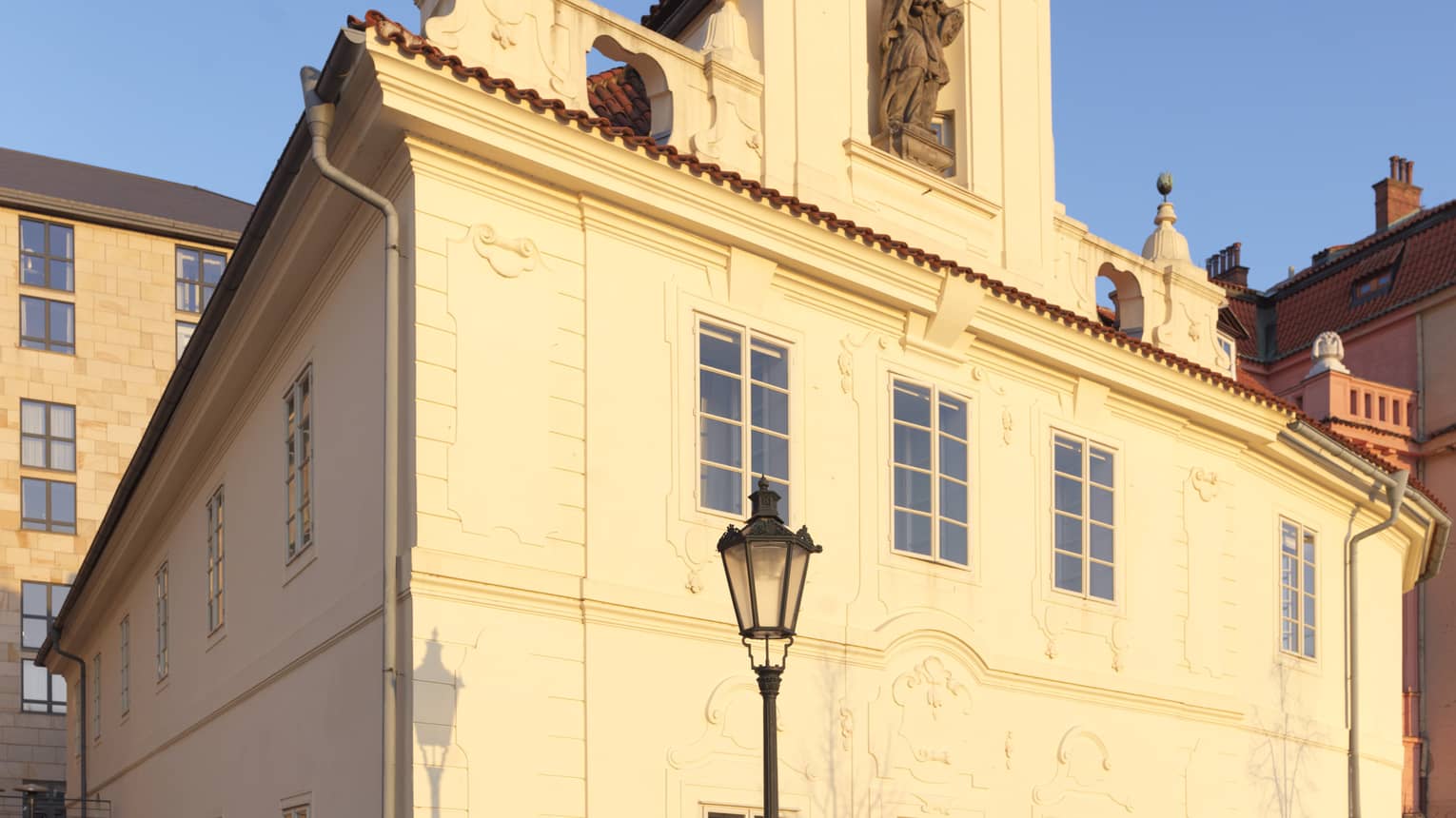 Sun shines on historic Barogue Building against blue sky
