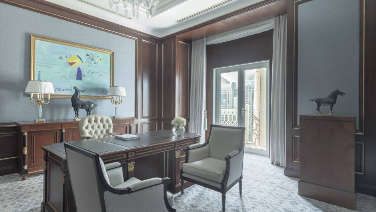 Elegant office with carpet, wooden executive desk, two arm chairs, and walk-out terrace