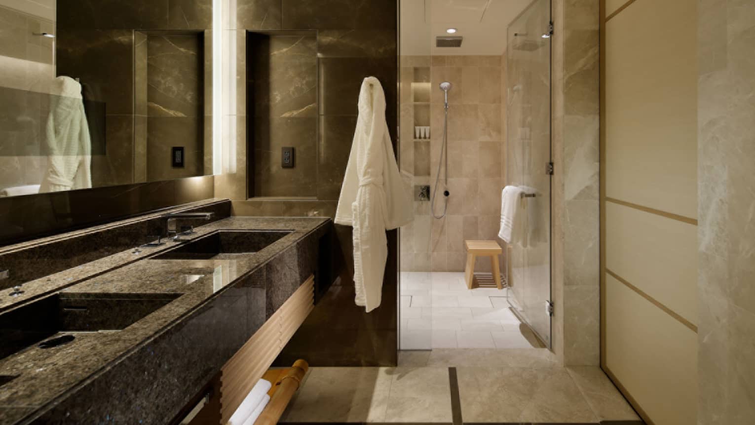 Luxury bathroom with a double-sink vanity, marble finishes and a glass-enclosed shower area at Four Seasons